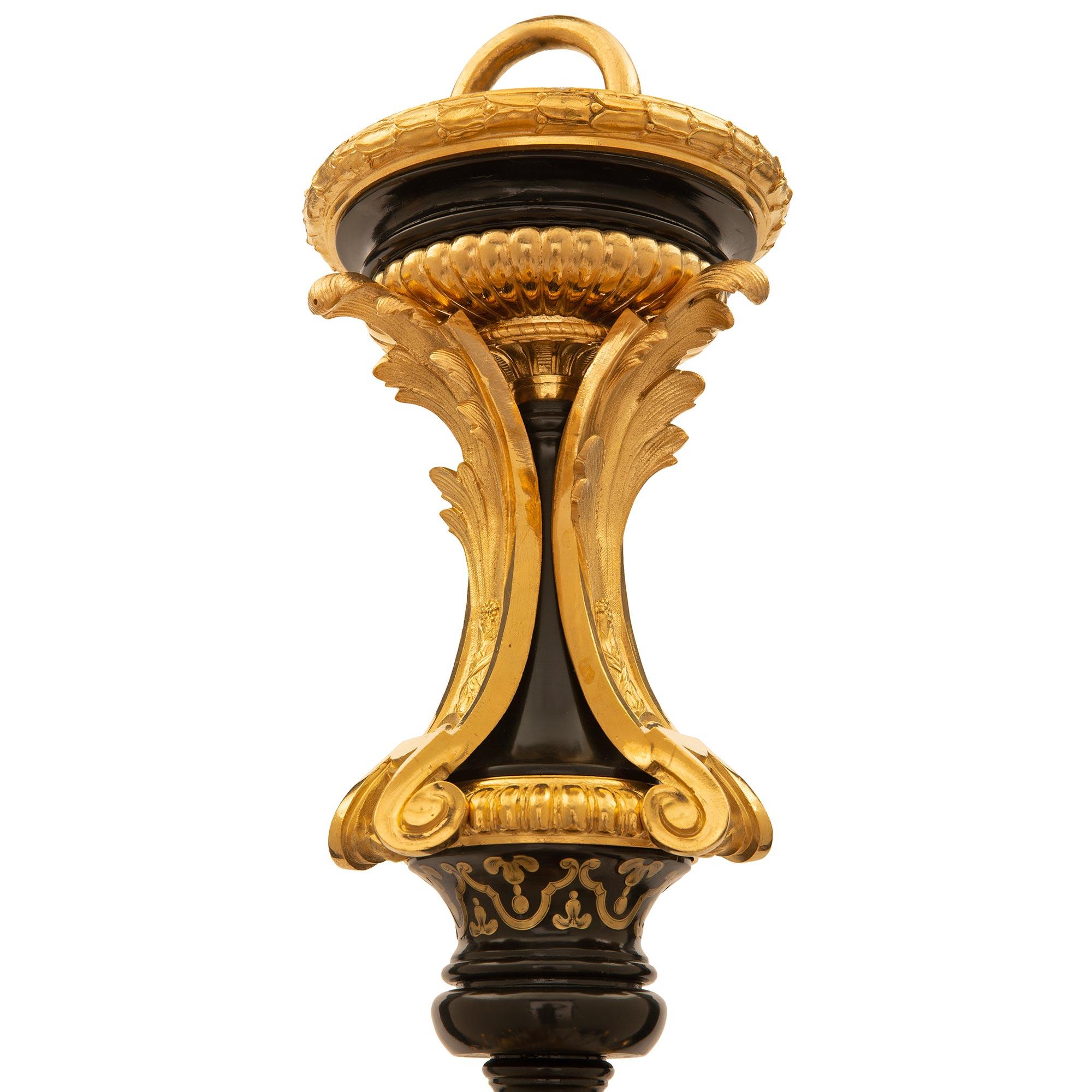 A stunning and extremely high quality French 19th century Louis XVI st. Ebony, ormolu Tortoiseshell and brass inlaid chandelier from the collection of Charles Aznavour. The twenty seven light chandelier is centered by a striking richly chased ormolu