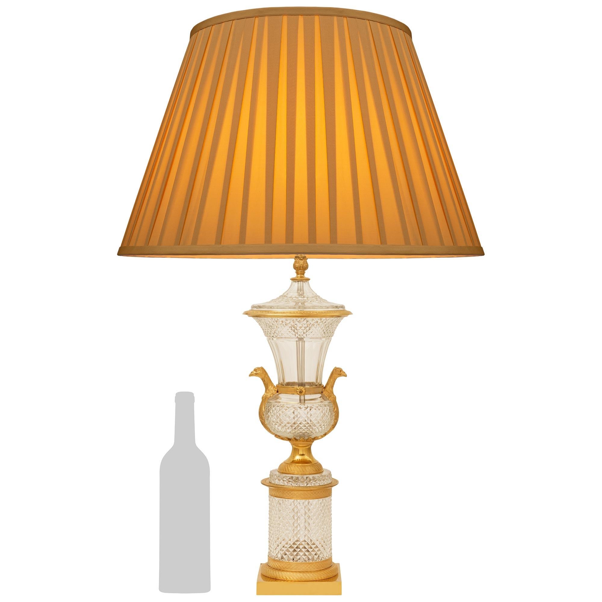 Lámpara francesa del siglo XIX de cristal y ormolu de estilo Luis XVI de gran calidad. Esta elegante lámpara se eleva sobre una base cuadrada de Ormolu debajo de un zócalo circular finamente cincelado que sostiene el jarrón de cristal tallado en