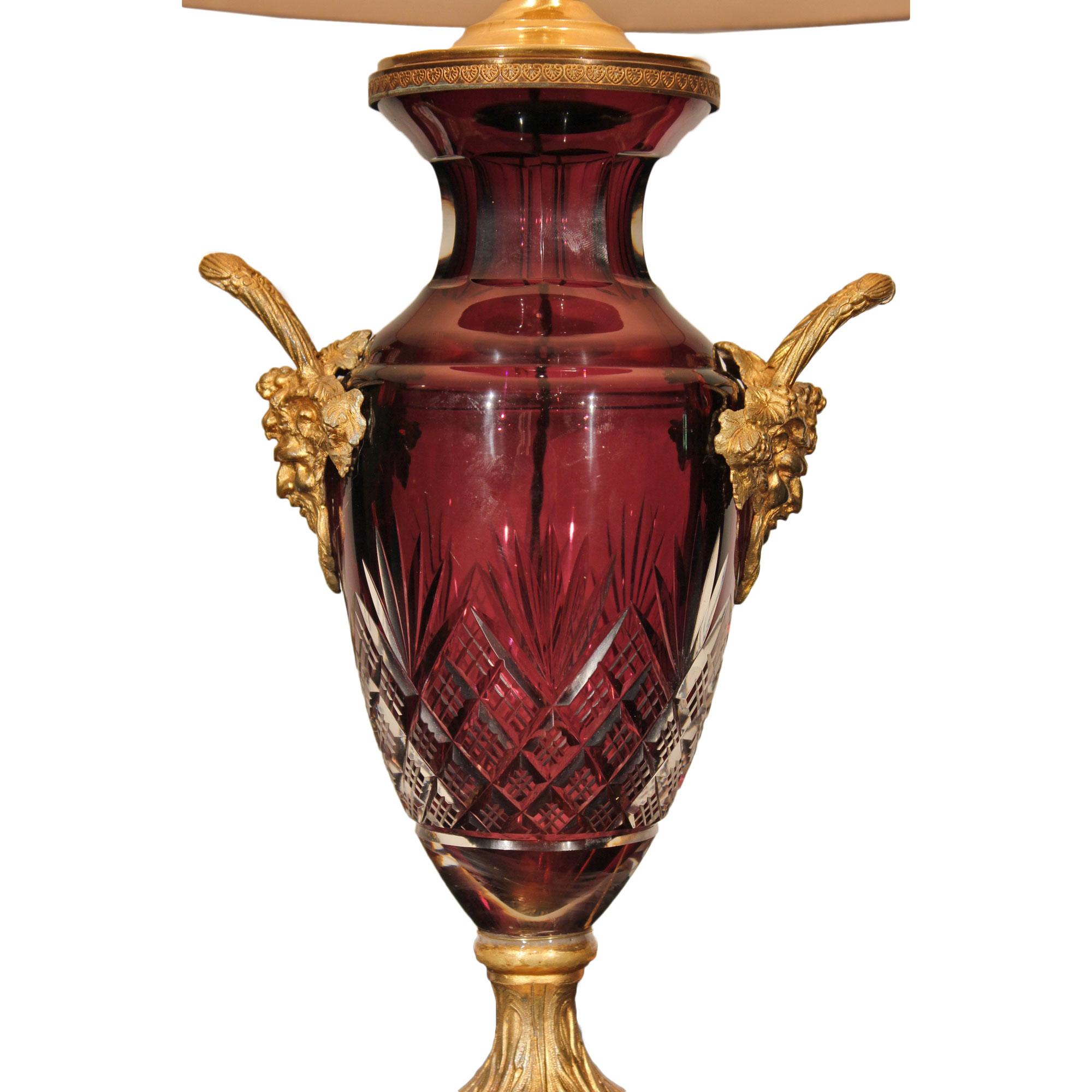 A very attractive French 19th century Louis XVI st. cut crystal urn mounted into a lamp. The lamp is raised on a square base with richly chased ormolu pedestal. Above is the wonderfully cut crystal baluster shaped urn with Oxblood red interior. The
