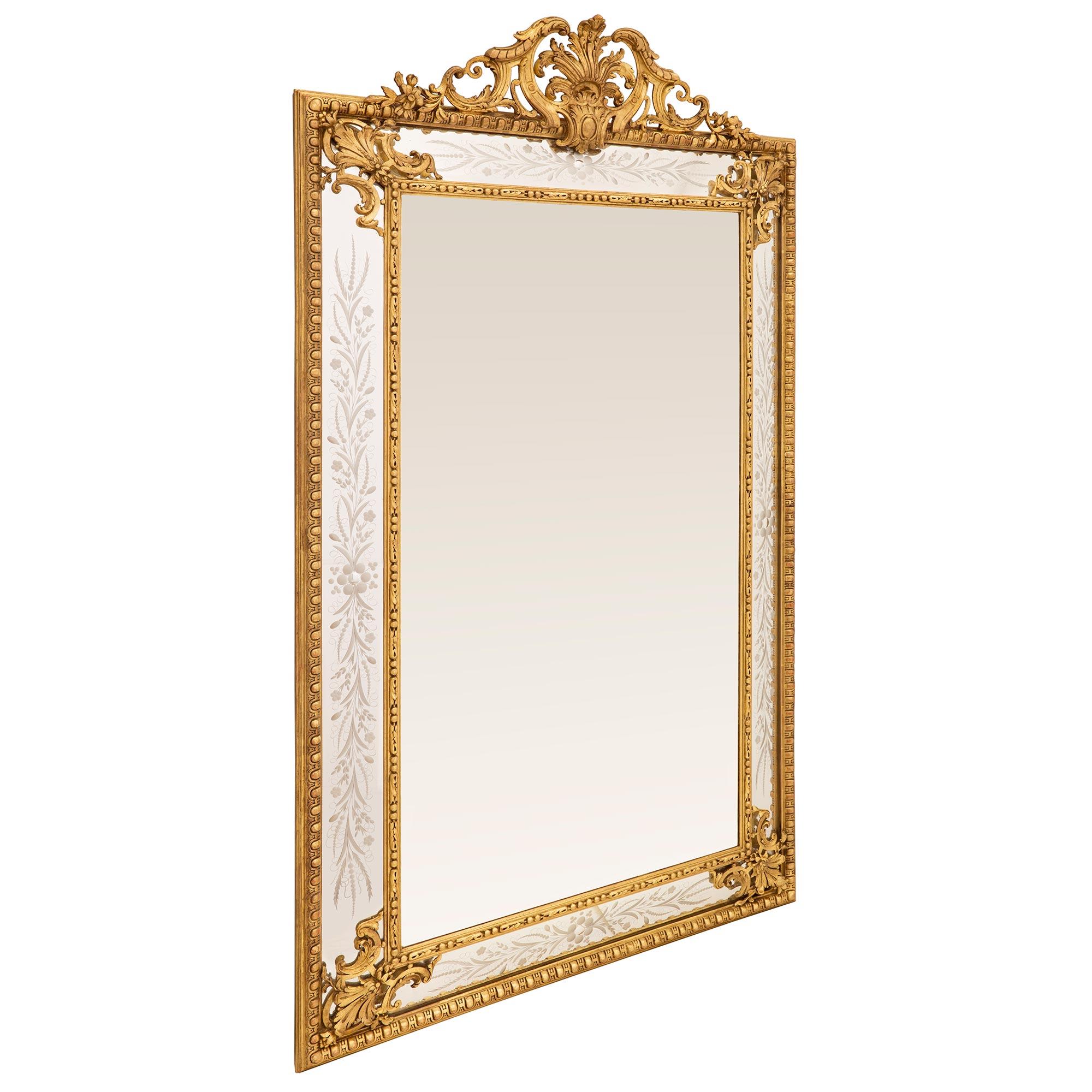 A stunning and extremely decorative French 19th century Louis XVI st. double framed giltwood mirror. The central original mirror plate is set within a lovely beaded and foliate band. The all original outer mirror plates are each decorated with
