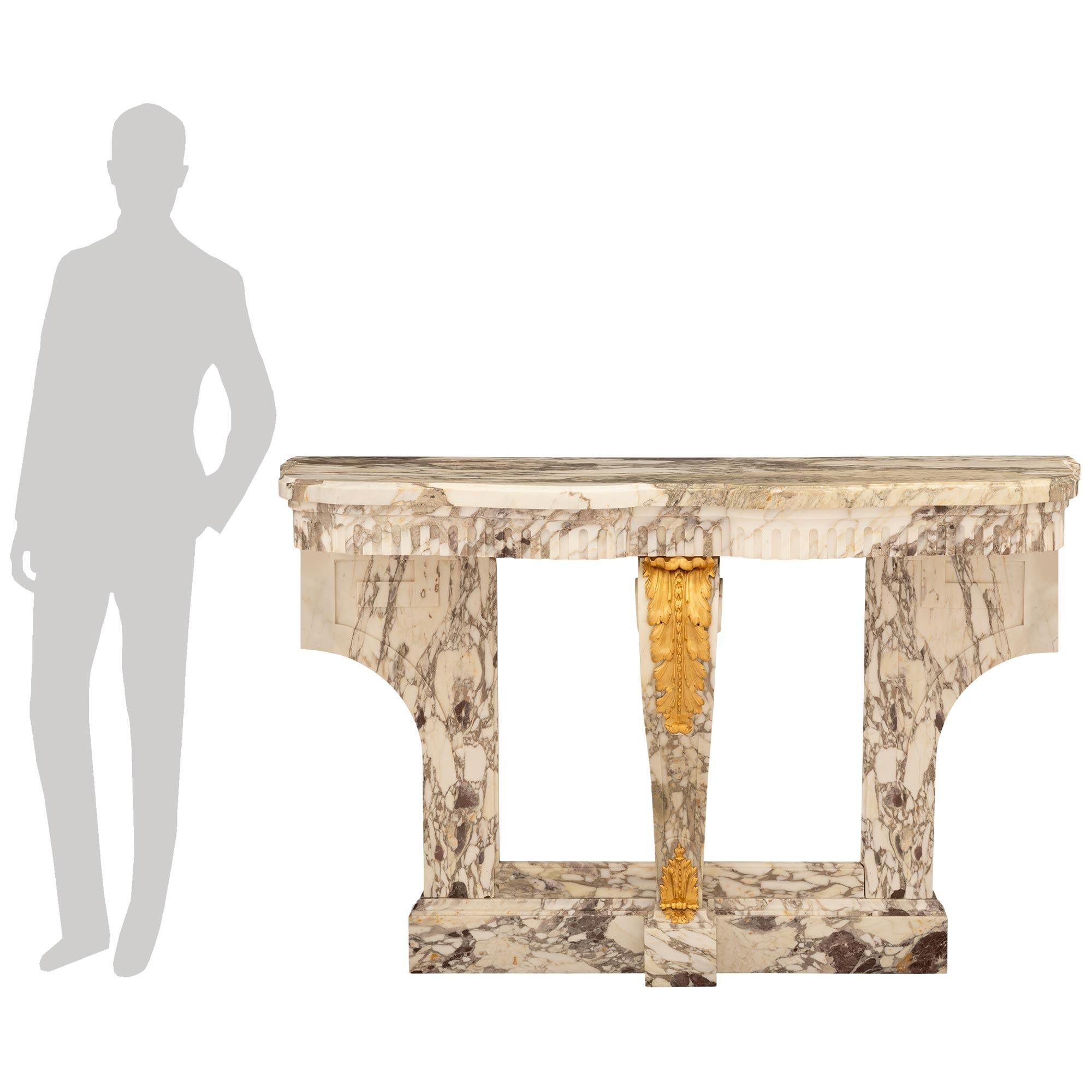 An attractive and most elegant French 19th century Louis XVI st. Fleur de Pêcher marble and Ormolu console. This impressive wall mounted console is supported on a mottled marble base and raised by two tapered backplates with recessed panels and a