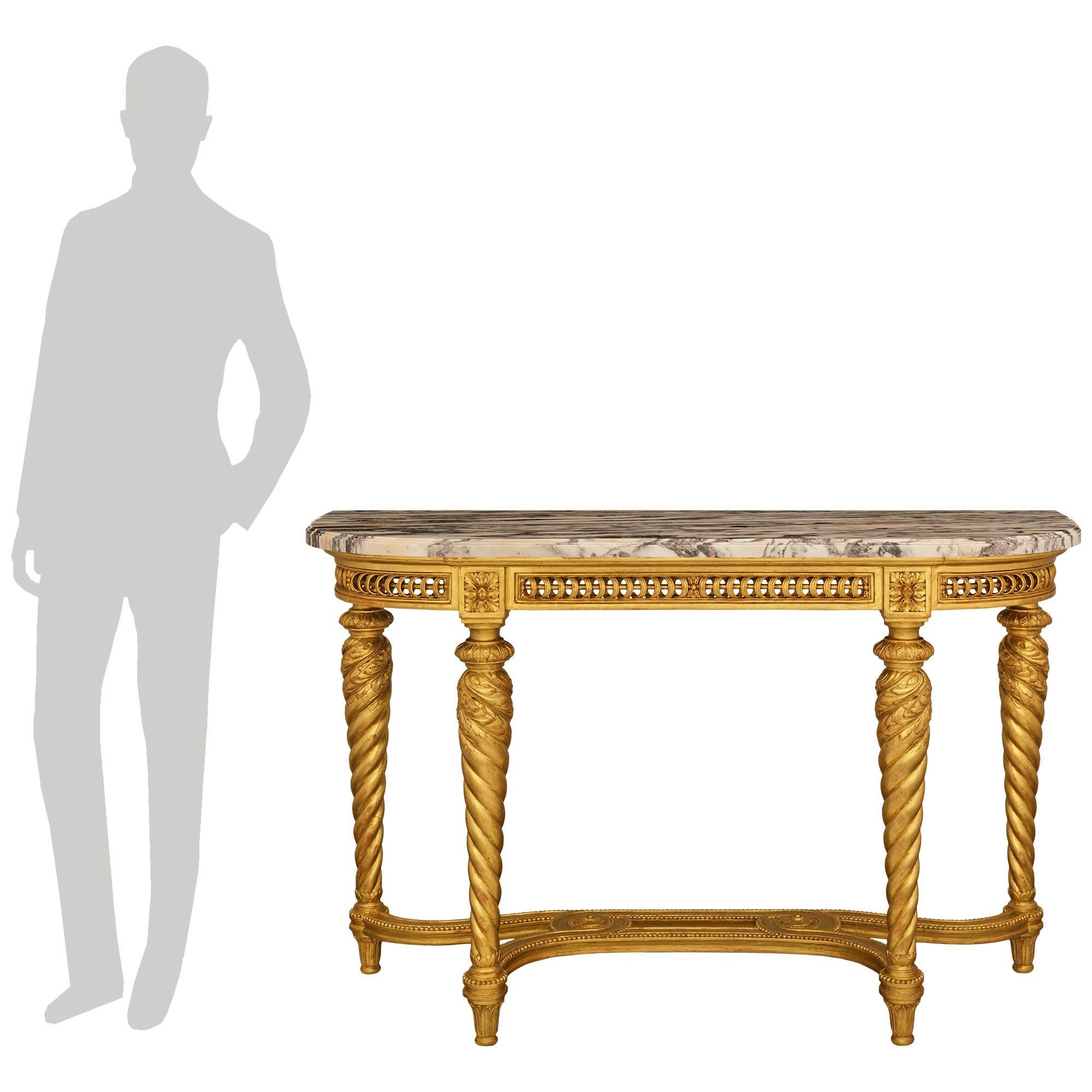 Un'elegante e pregiata console francese del XIX secolo in legno dorato e marmo di Breccia Viola. Questa meravigliosa consolle indipendente è sollevata su quattro piedi affusolati in legno d'orato a foglia d'acanto, al di sotto di un'intelaiatura