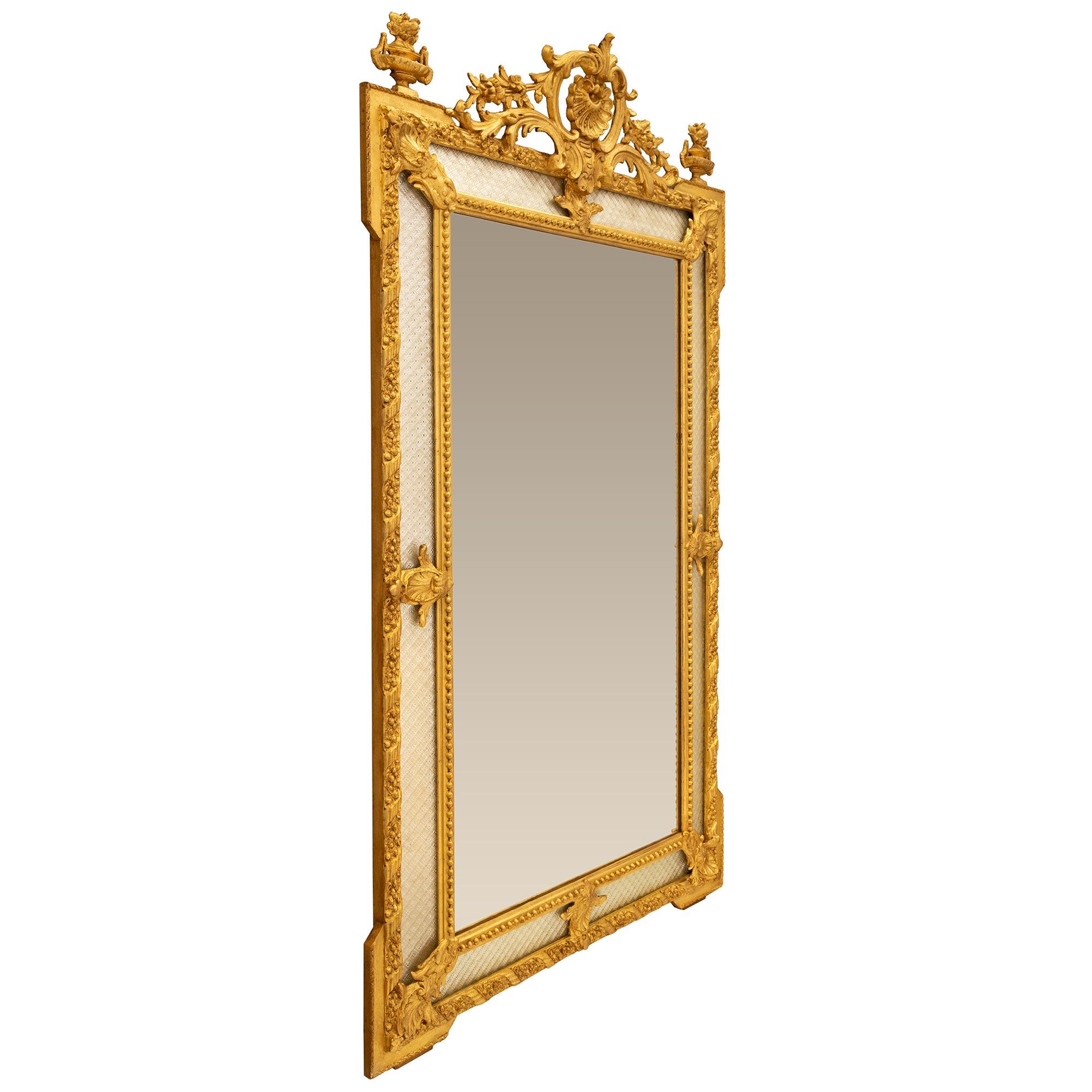 An exceptional and most elegant French 19th century Louis XVI st. giltwood double framed mirror. The mirror retains all of its original glass plates throughout with the central mirror plate framed within a charming beaded wrap around band. The outer