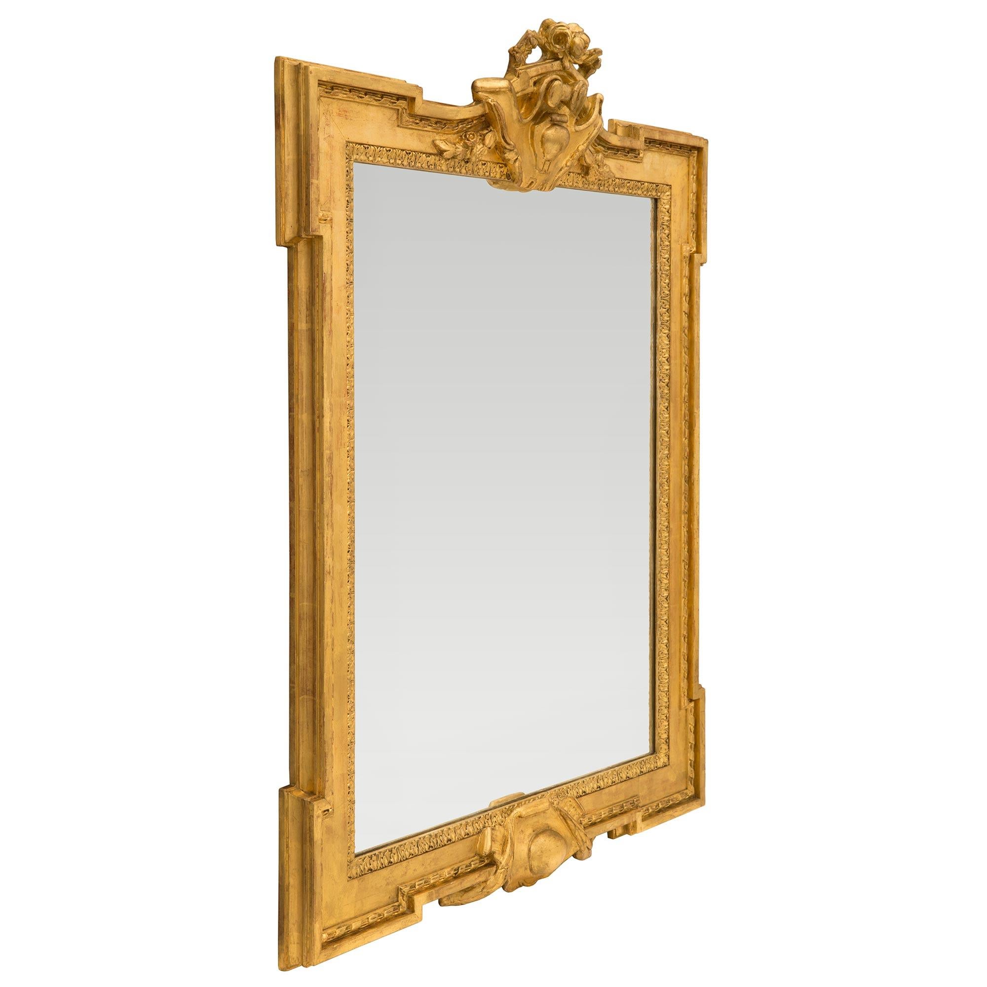A beautiful French 19th century Louis XVI st. giltwood mirror. The mirror retains its original mirror plate set within an architectural and most decorative mottled frame with a finely carved foliate border and wrap around twisted ribbon. At the