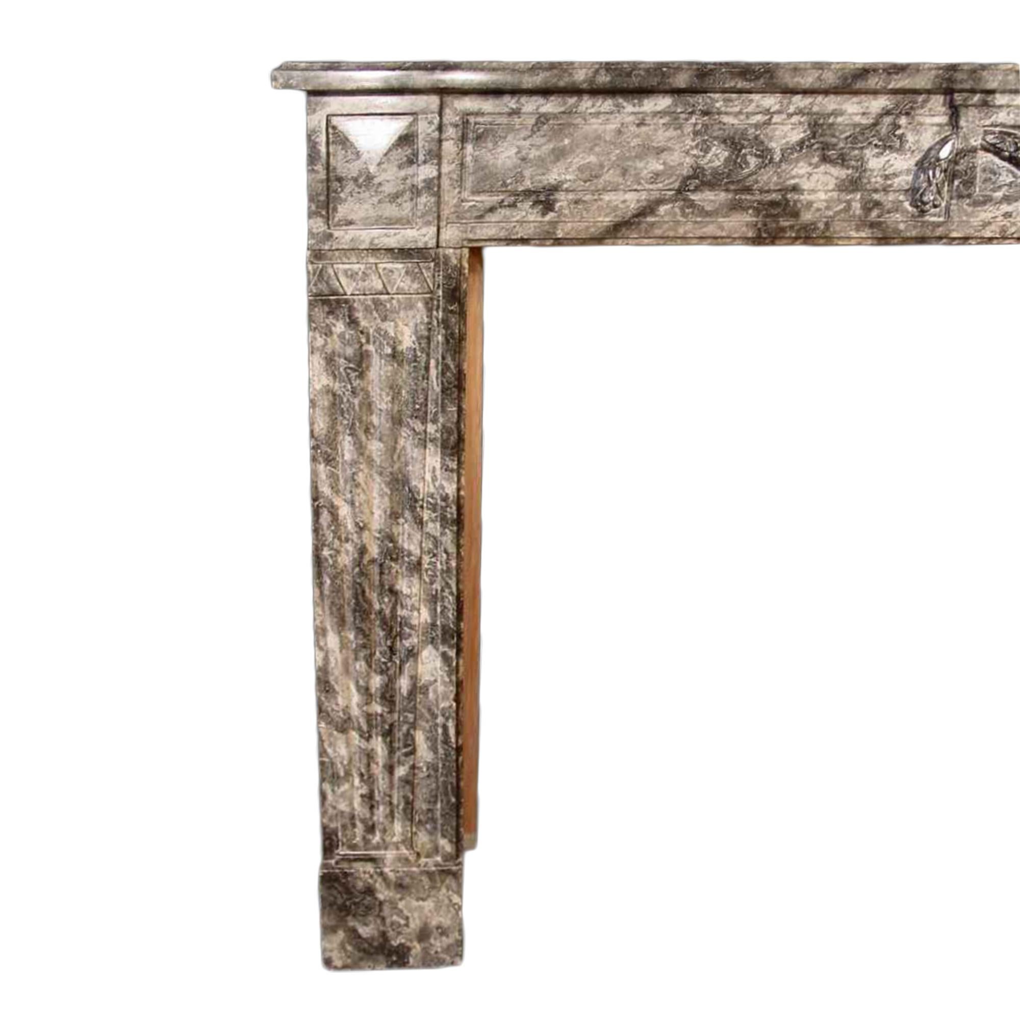 A very important French 19th century Louis XVI st. 'Gris St. Anne' marble mantel. The two solid marble jambs are fluted while the bandeau has a square design on each end and on each side of a richly carved laurel garland in the center. Interior