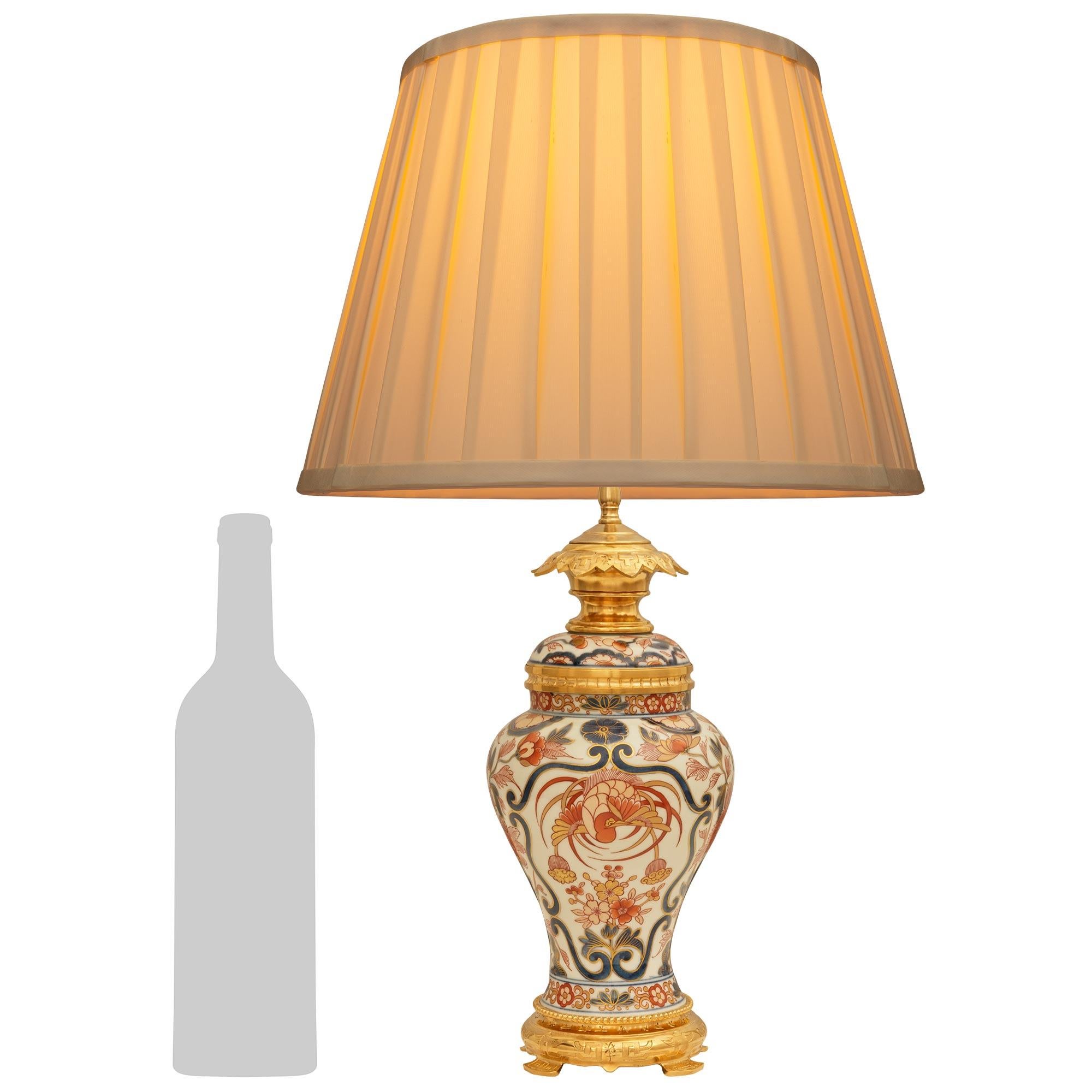 Charmante lampe en porcelaine d'Imari et bronze doré de style Louis XVI du XIXe siècle. Cette élégante urne à couvercle convertie en lampe est surélevée par quatre pieds en canard sous un socle rond en bronze doré décoré de caractères japonais sous