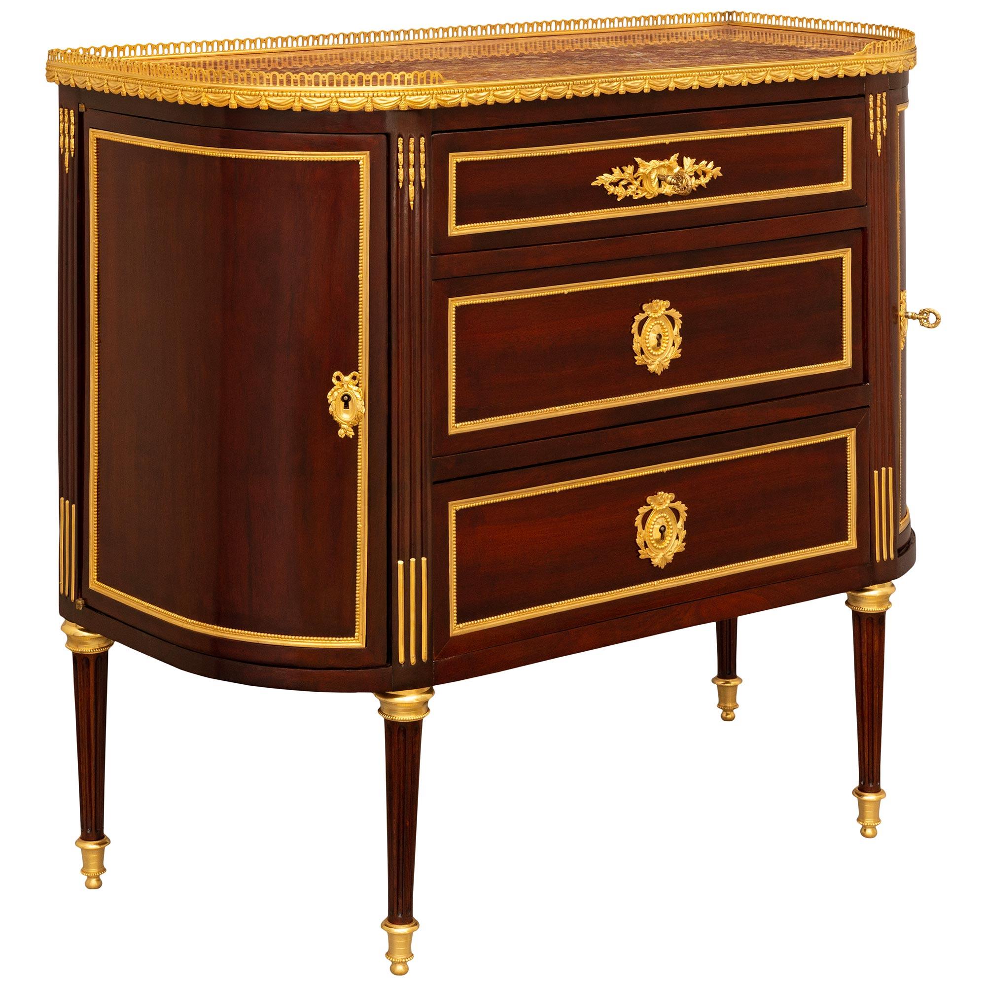 A most elegant and high quality French 19th century Louis XVI st. Mahogany, Ormolu and Lumachella marble commode. This beautifully designed 