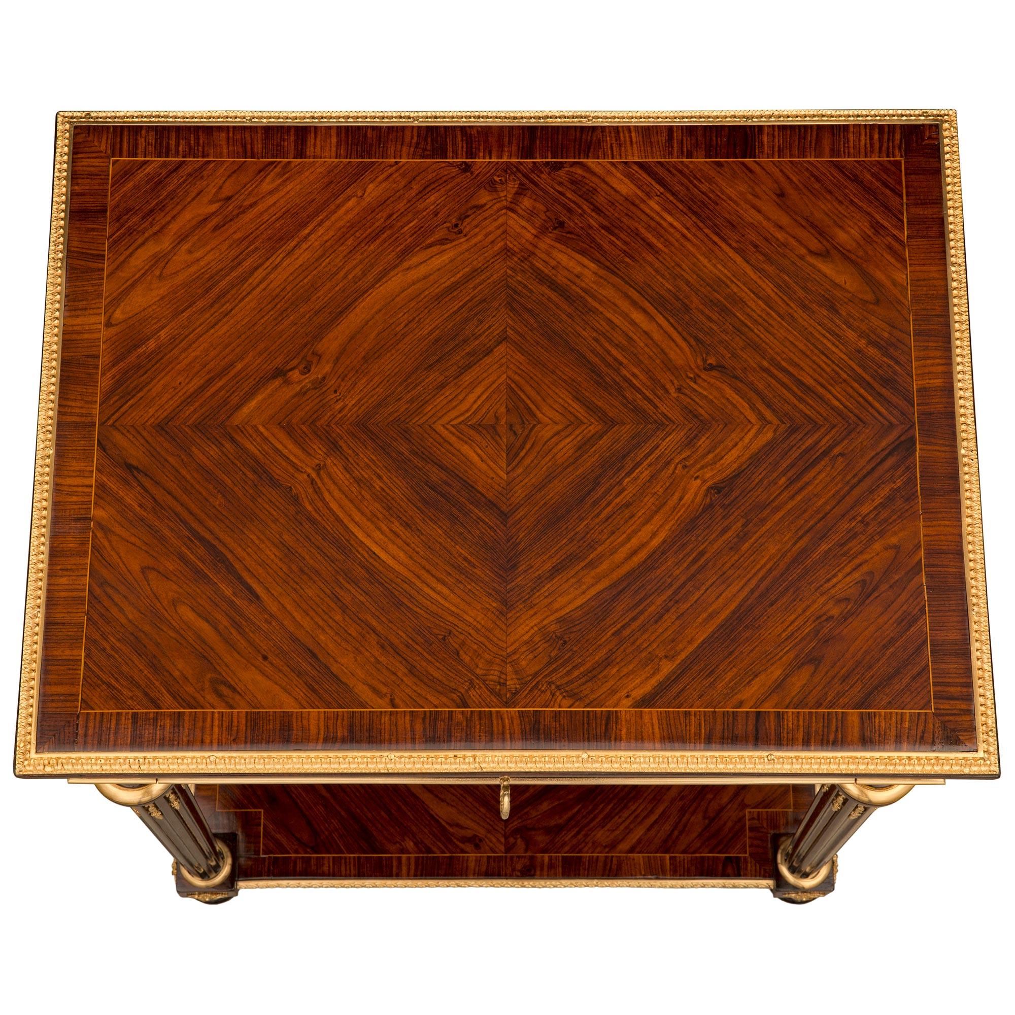A stunning and extremely high quality French 19th century Louis XVI st. Mahogany, Rosewood, and ormolu side table attributed to Sormani. The table is raised by elegant topie shaped feet with fine fitted foliate ormolu sabots. Above the feet are