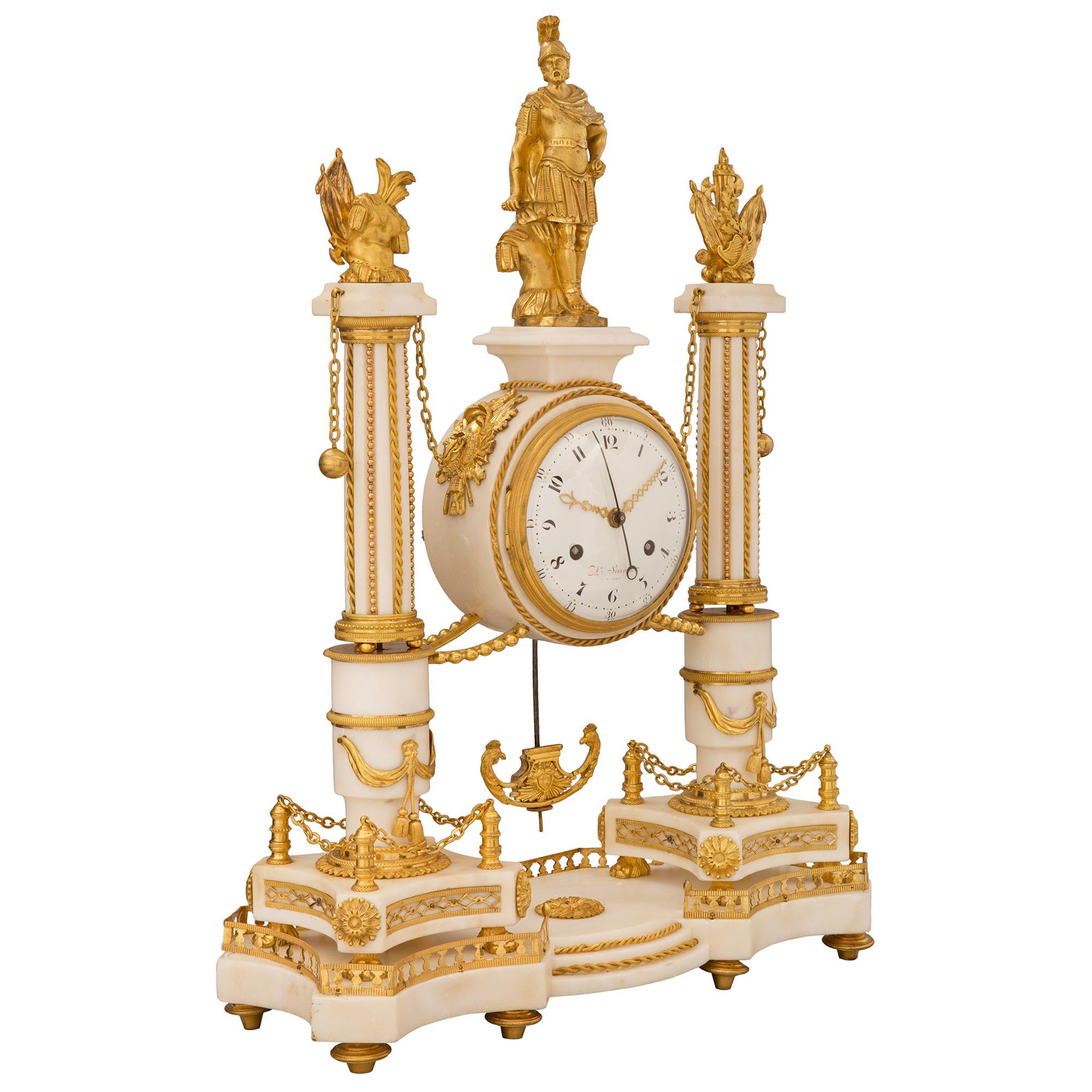 A spectacular and extremely high quality French early 19th century Louis XVI st. white Carrara marble and ormolu clock, signed Simona à Paris, circa 1819. The clock is raised by six elegant topie shaped feet below the exceptional and most decorative