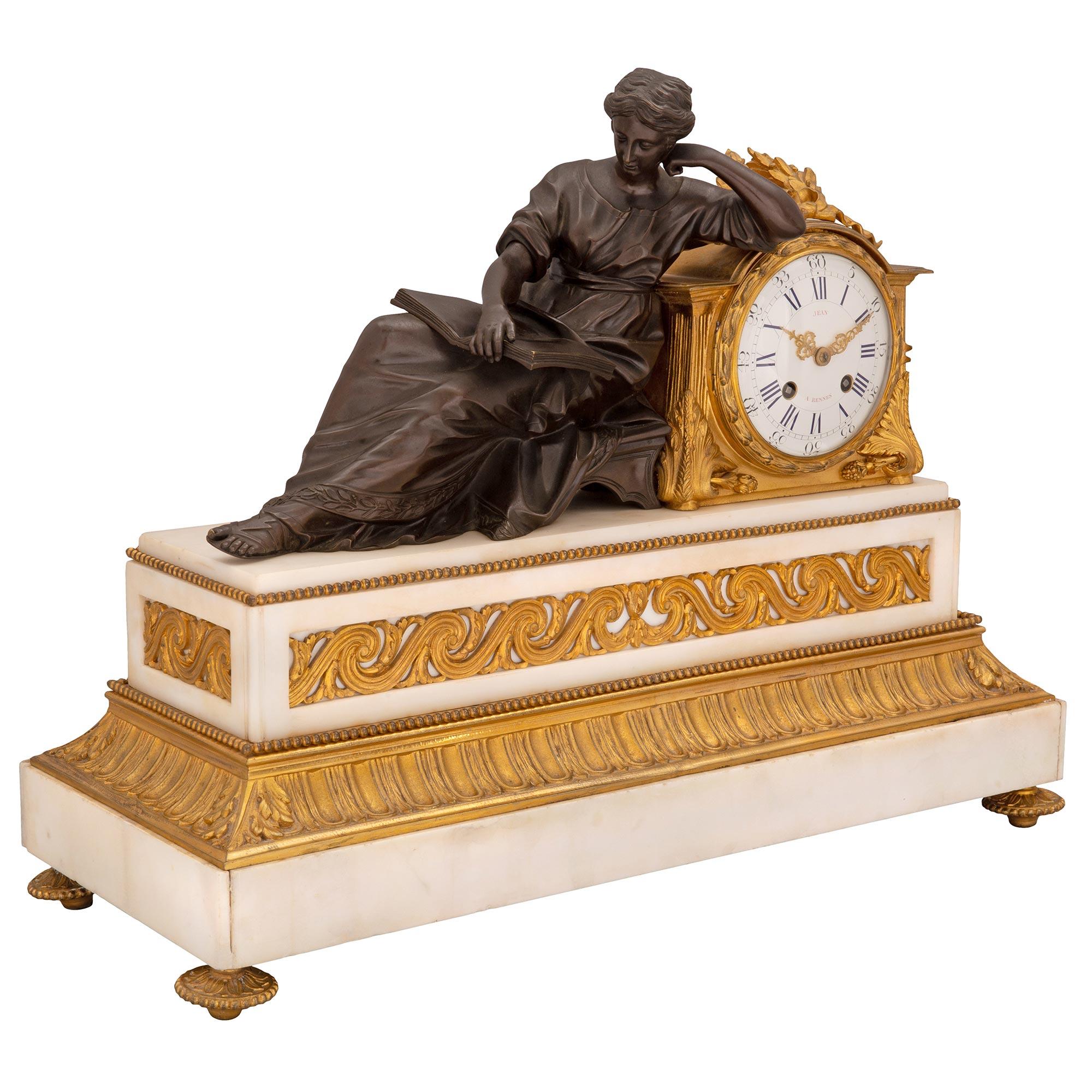 An elegant and high quality French 19th century Louis XVI st. white Carrara marble, ormolu and patinated bronze clock, signed Jean, A Rennes. The clock is raised by four fine topie shaped feet with a lovely foliate and beaded design. The rectangular