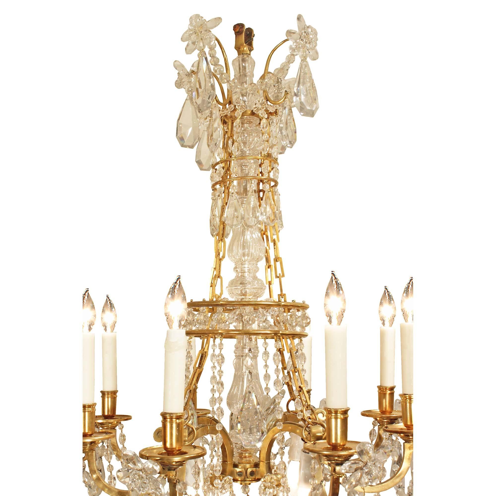 An extremely high quality French early 19th century Louis XVI st. ormolu and Baccarat crystal Marie Antoinette chandelier. Each main scrolled arm branches off in two, for a total of eight lights. The arms are decorated with large kite shaped and