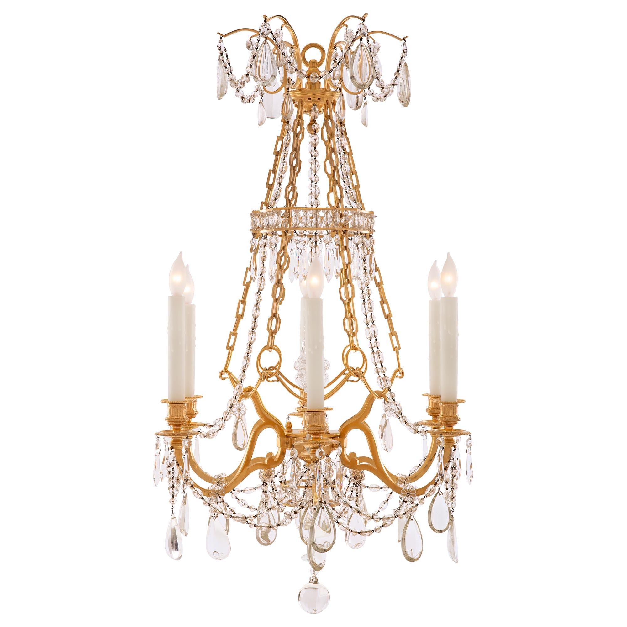 A beautiful and very high quality French 19th century Louis XVI st. ormolu and Baccarat crystal Marie Antoinette chandelier. The six arm chandelier is centered by a solid Baccarat crystal ball below a lower crown like ormolu and crystal pendant