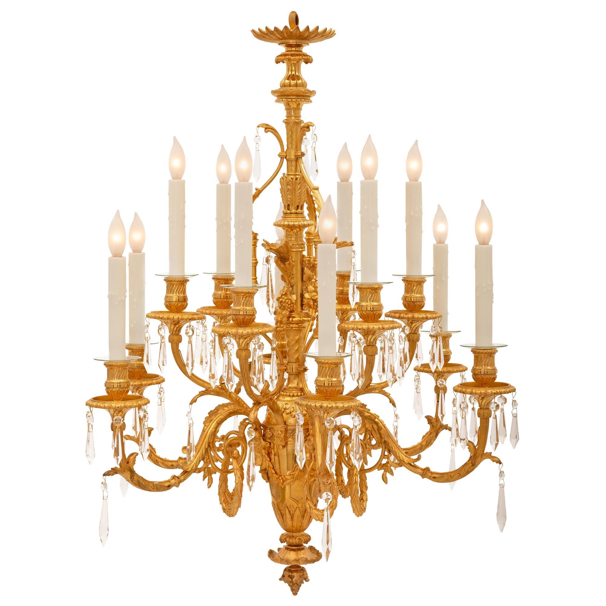 A stunning French 19th century Louis XVI st. ormolu and Baccarat crystal chandelier. The twelve arm chandelier is centered by a beautiful richly chased bottom acorn finial below lovely foliate designs and the circular tapered body. The body is