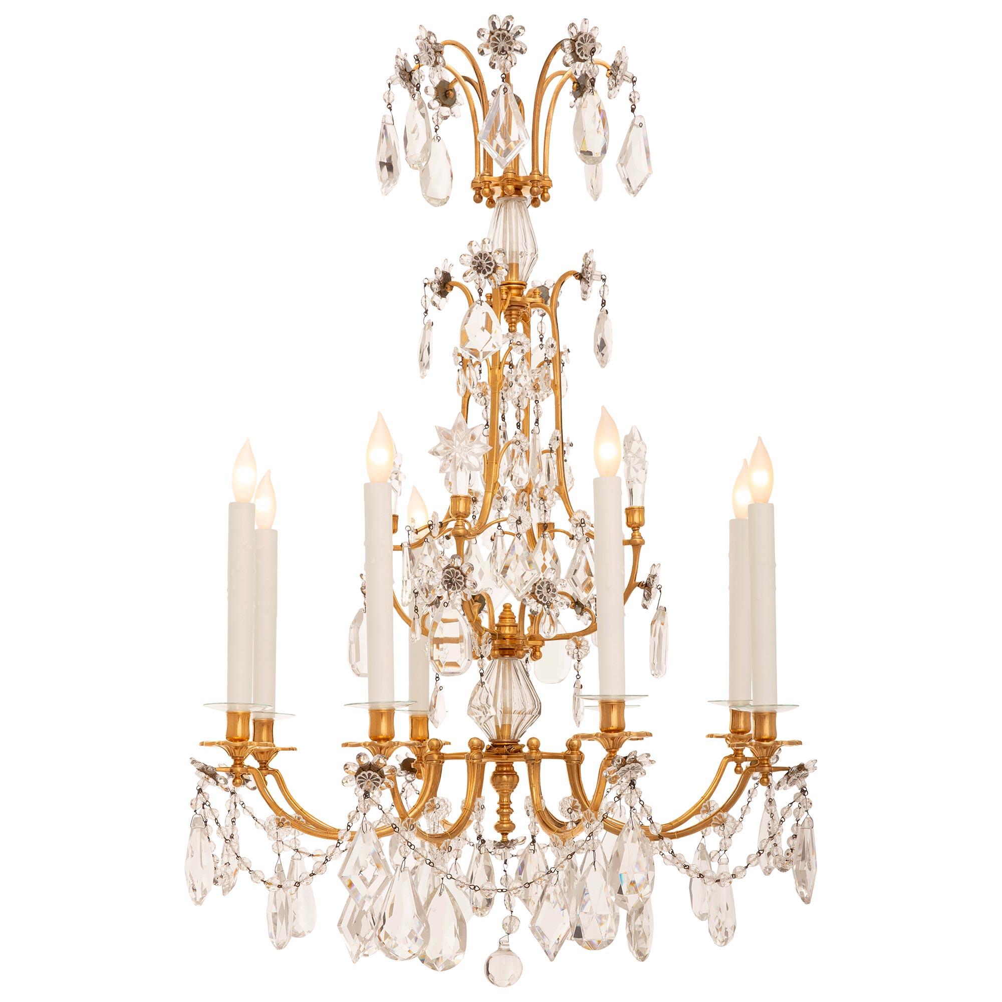A stunning and high quality French 19th century Louis XVI st. Ormolu and Baccarat Crystal chandelier. This wonderful eight arm eight light chandelier is centered by a solid Crystal ball pendant which hangs with smaller faceted Crystal balls from a