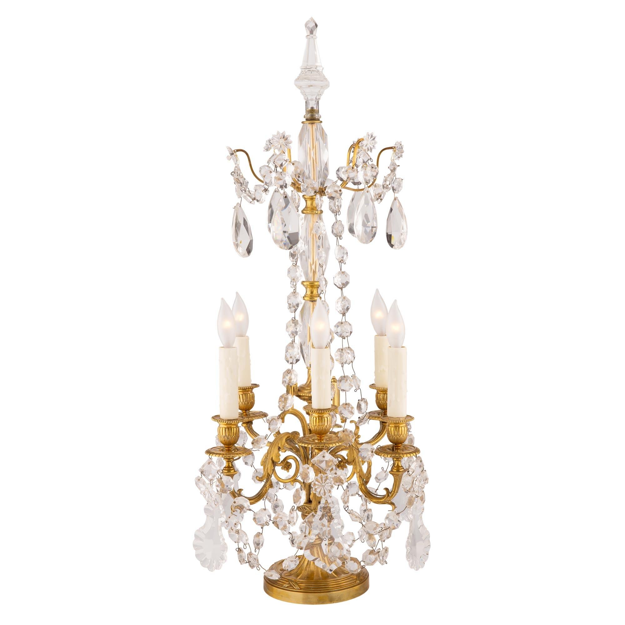 A most attractive French 19th century Louis XVI st. ormolu and Baccarat crystal Girandole lamp. The single Girandole is raised by an elegant circular base with a fine tied fluted wrap around band. Above the fluted socle pedestal are six beautifully