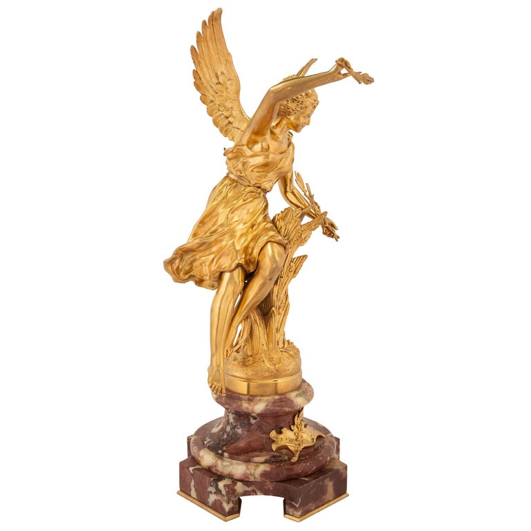 An elegant French 19th century Louis XVI st. ormolu and Brèche Violette marble statue of L'Automne signed by Rancoulet. The statue is raised by a striking and uniquely shaped Brèche Violette marble square base with most decorative concave corners
