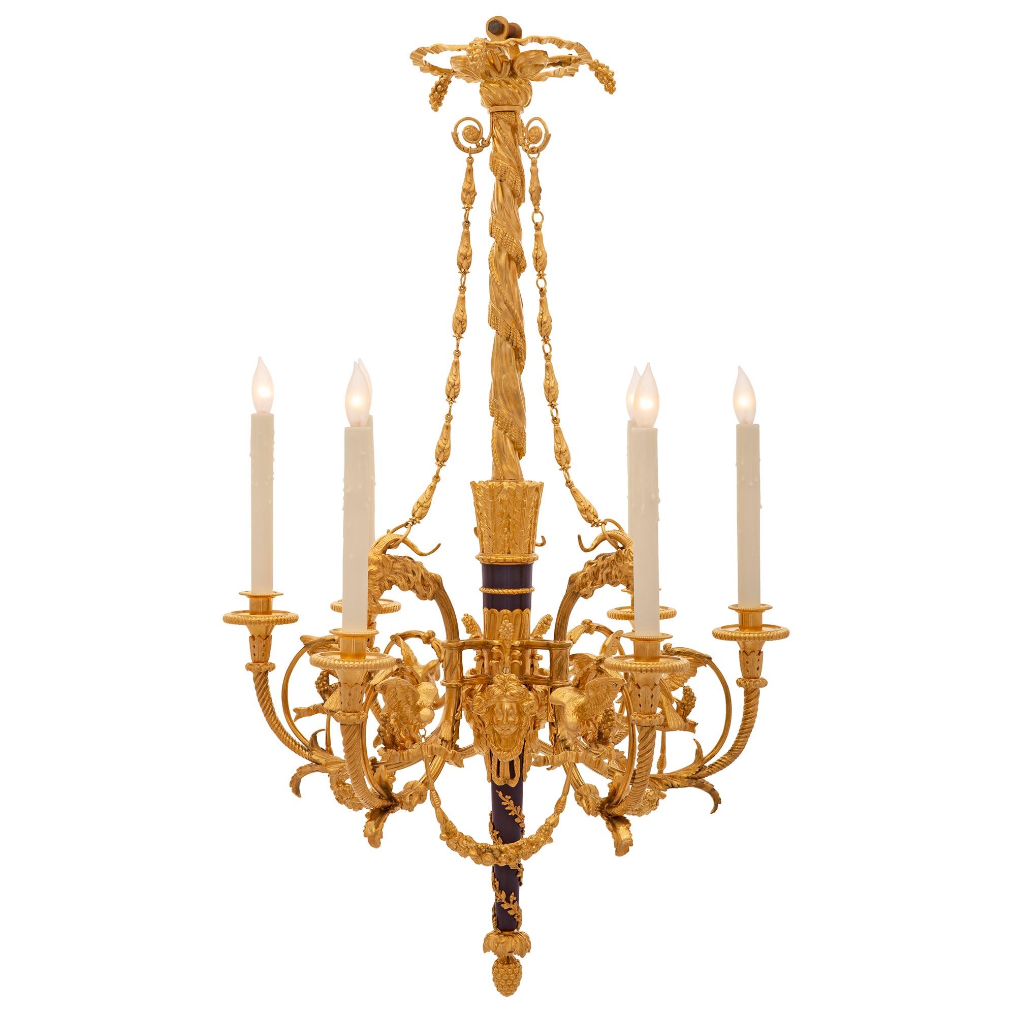 A stunning and high quality French 19th century Louis XVI st. ormolu and cobalt blue enamel chandelier. The chandelier is centered by a beautiful inverted ormolu acorn final below the elegant tapered cobalt blue enamel central fut encased with