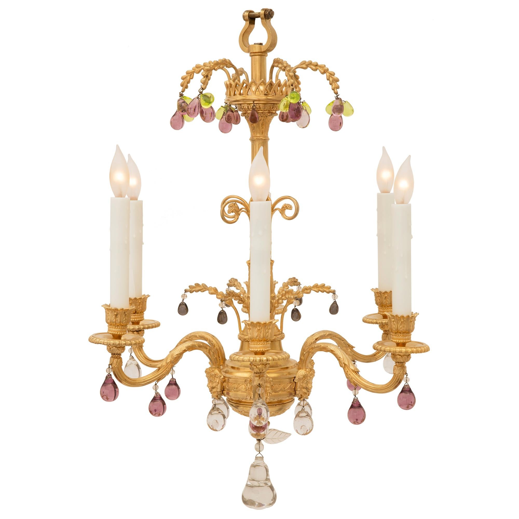 A stunning French 19th century Louis XVI st. ormolu and crystal chandelier. The six light chandelier is centered by a fine solid crystal pendant in the shape of a pear below additional finely cut crystal leaves. Above is a striking bottom reserve