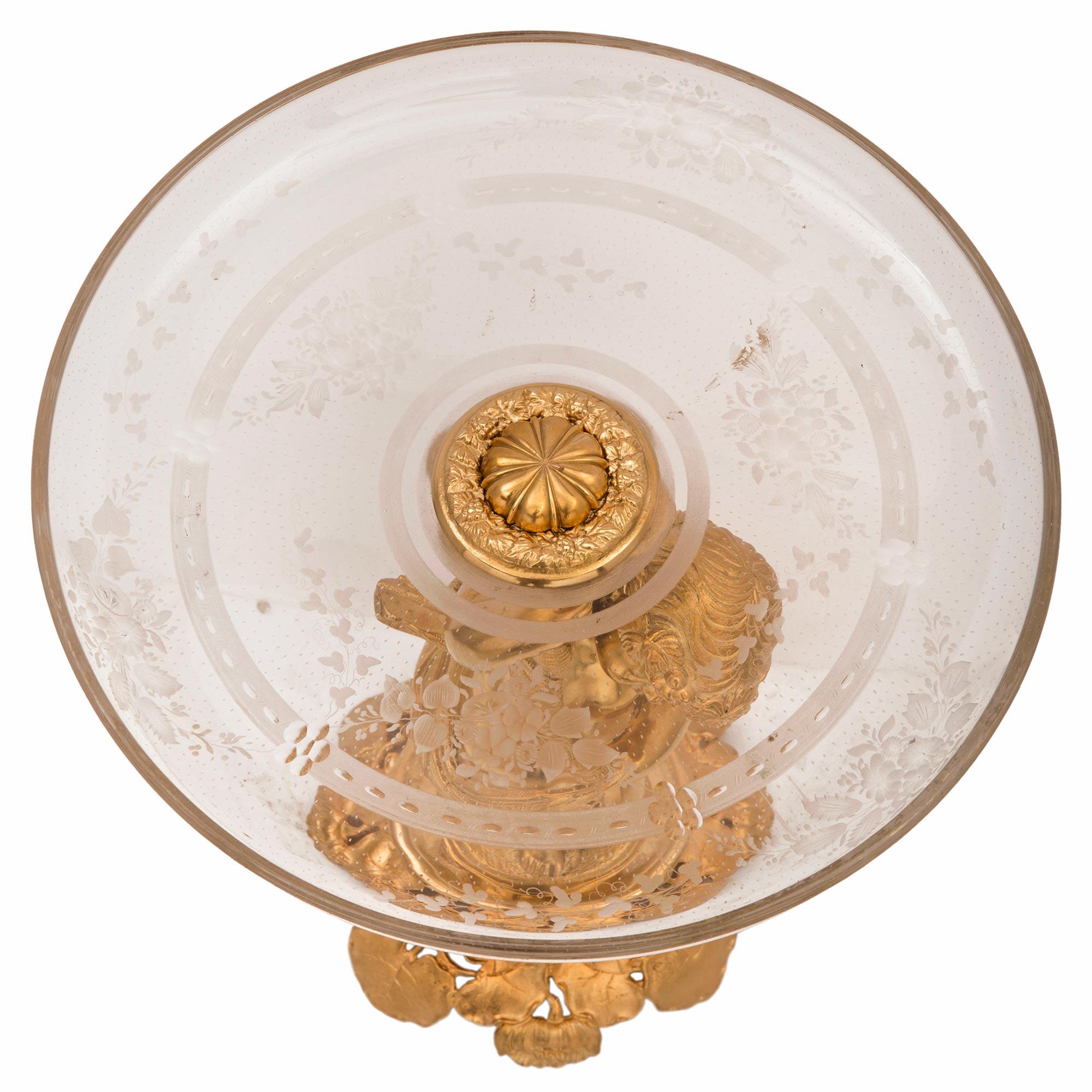 A charming and high quality French 19th century Louis XVI St. ormolu and Baccarat crystal presentoir centerpiece. The centerpiece is raised by a beautiful wonderfully executed pierced grape leaf designed base. At the center is the charming and