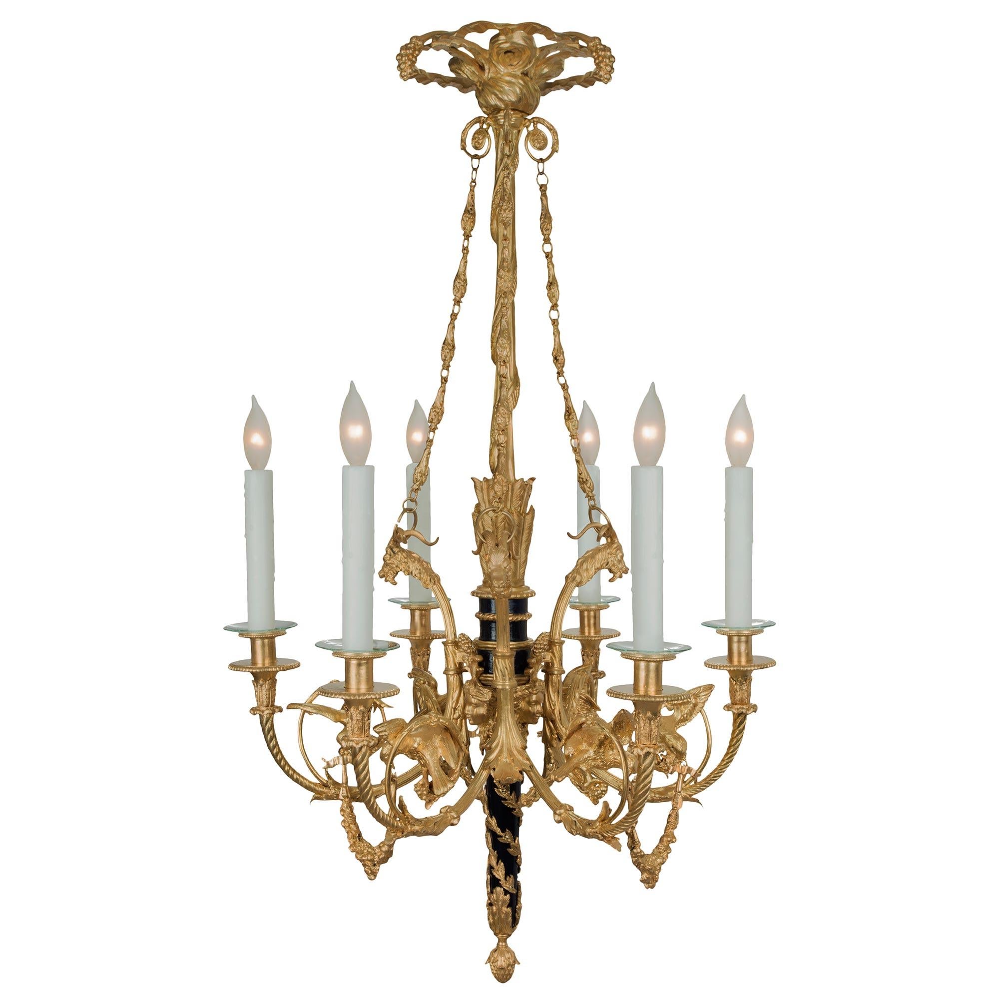 A sensational and high quality French 19th century Louis XVI st. ormolu and cobalt blue enamel six light chandelier. The chandelier is centered by an inverted acorn final leading up richly chased foliate movements encasing the enameled cobalt blue