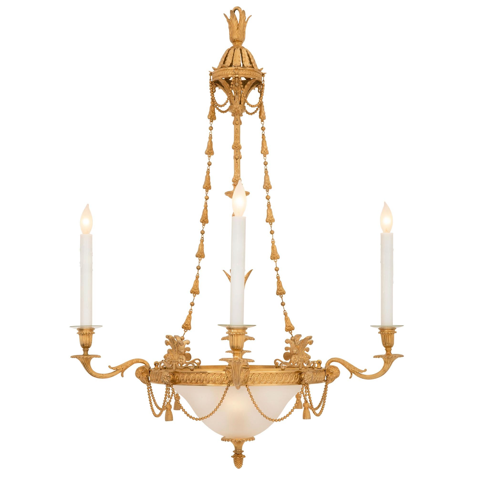 A most elegant French 19th century Louis XVI st. ormolu and frosted glass chandelier. The four arm five light chandelier is centered by a fine bottom acorn and reeded finial below the beautiful frosted glass dome which houses one light bulb giving