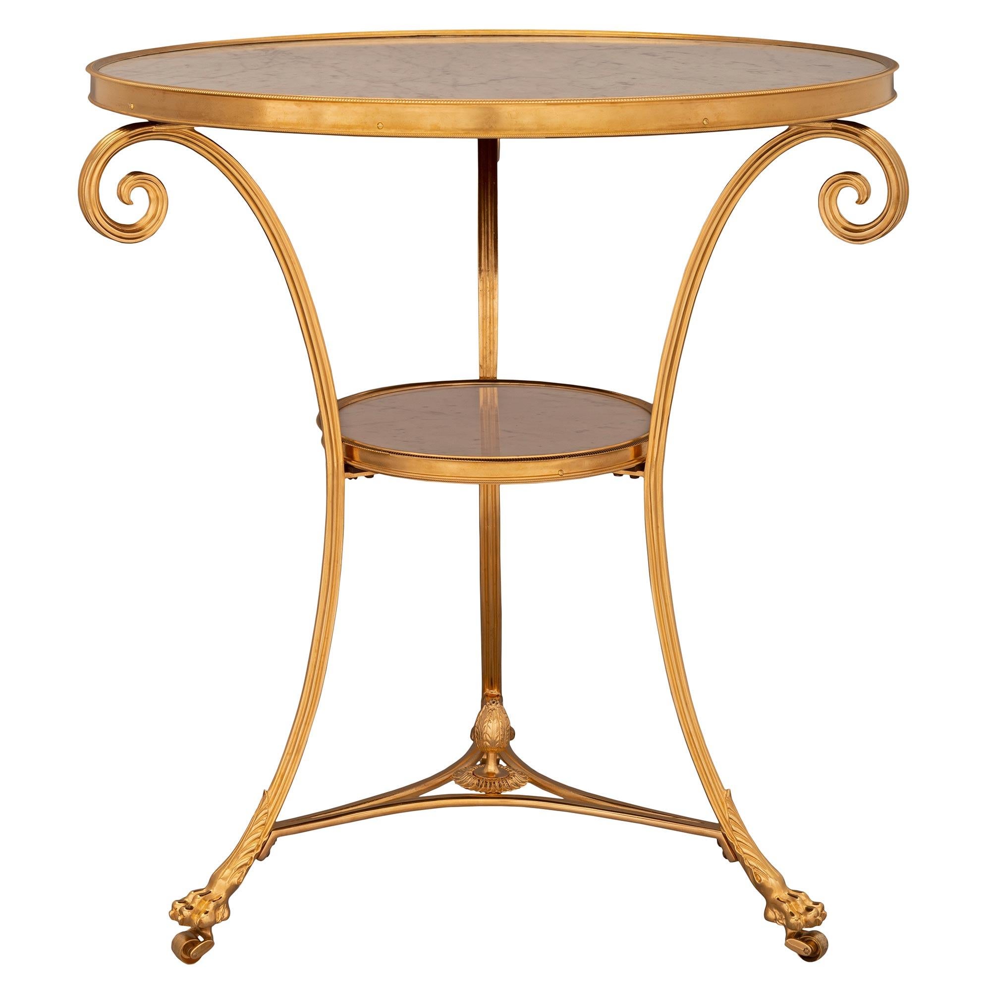 A striking French 19th century Louis XVI st. ormolu and white Carrara marble Gueridon side table. The table is raised by its original casters below handsome paw feet and large richly chased acanthus leaves. Each elegant lightly curved support is