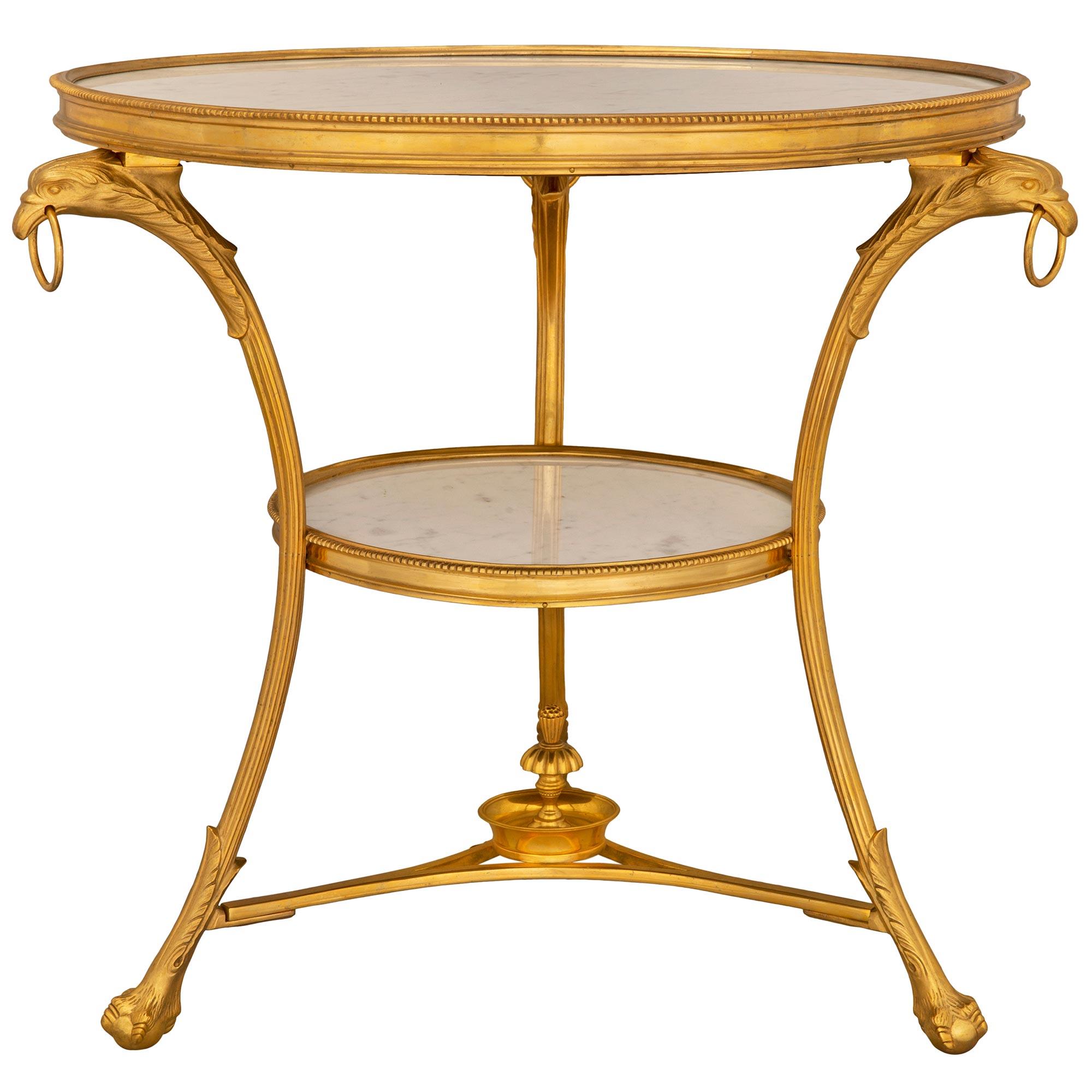 A striking and most elegant French 19th century Louis XVI st. ormolu and white Carrara marble gueridon side tables. Each table is raised by three lightly curved legs with handsome ball and claw feet adorned with superb acanthus leaves, and each