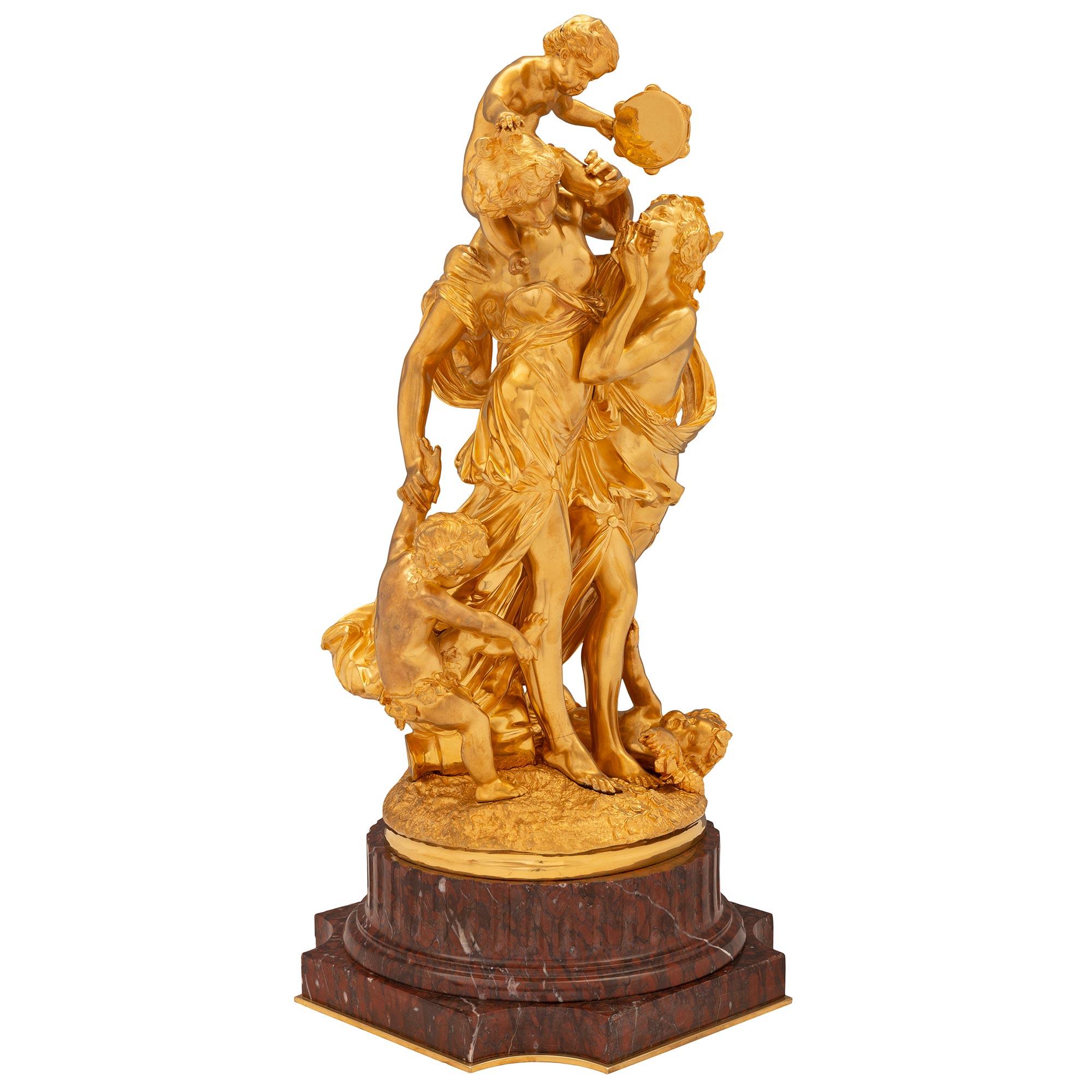 A striking and very high quality French 19th century Louis XVI st. ormolu and Rouge Griotte marble statue after Claude Michel Clodion. The charming statue is raised by a beautiful square Rouge Griotte marble base with concave corners, a fine bottom