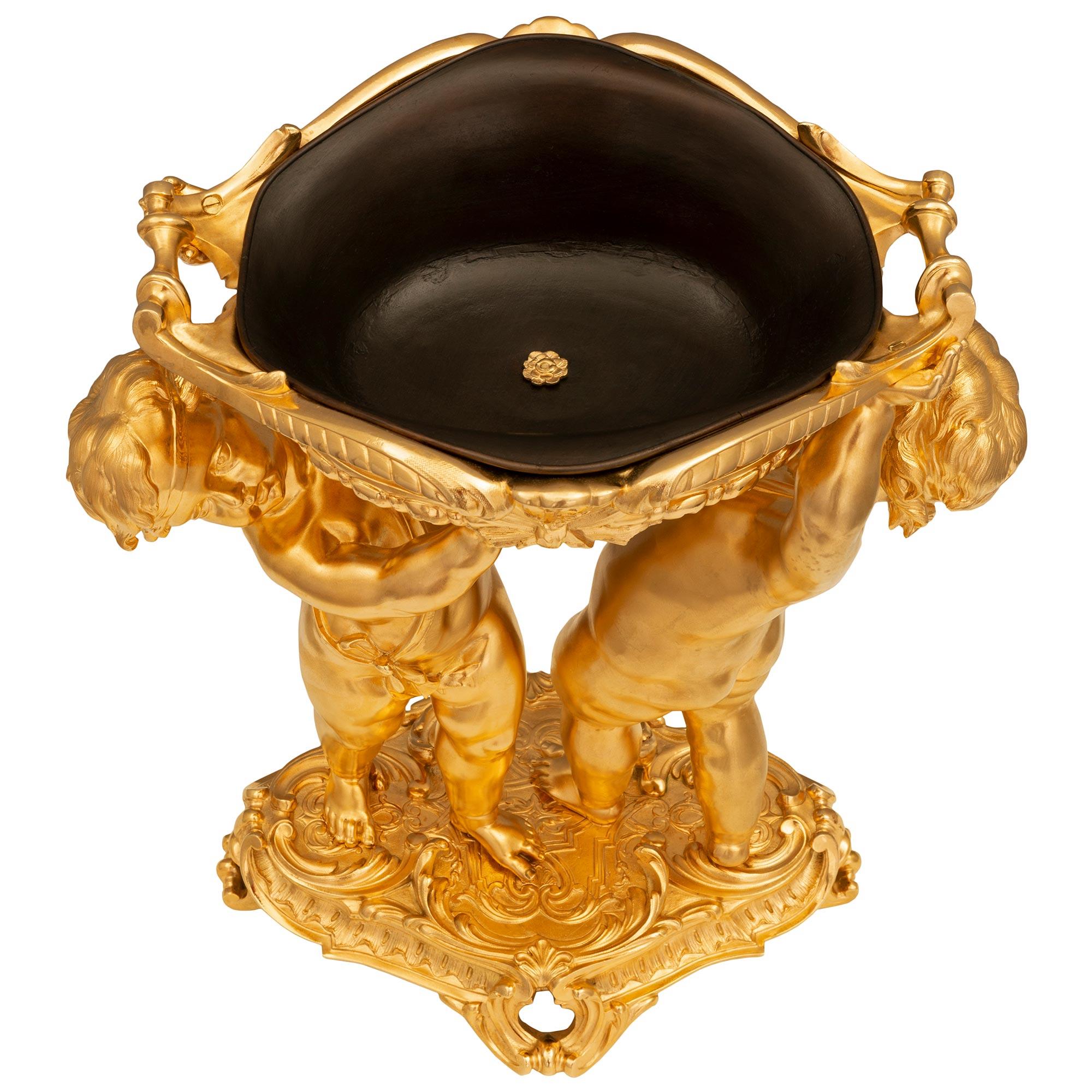 A stunning and extremely high quality French 19th century Louis XVI st. Belle Époque period ormolu and patinated bronze centerpiece. The centerpiece is raised by an elegant pierced oblong base with striking Rocaille designs, beautiful scrolled