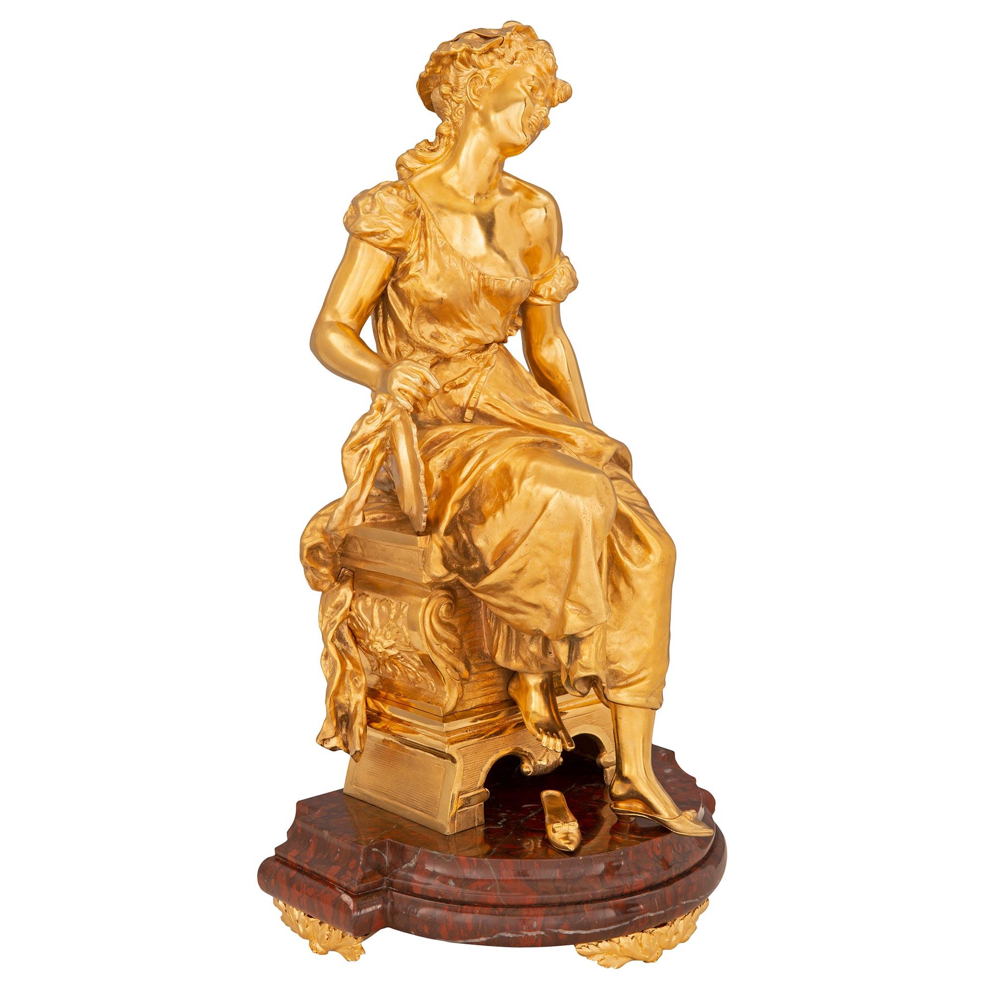 A stunning and extremely high quality French 19th century Louis XVI st. Belle Époque period ormolu and Rouge Griotte marble statue. The statue is raised by exceptional acanthus leaf ormolu feet below the most elegant thick Rouge Griotte marble base