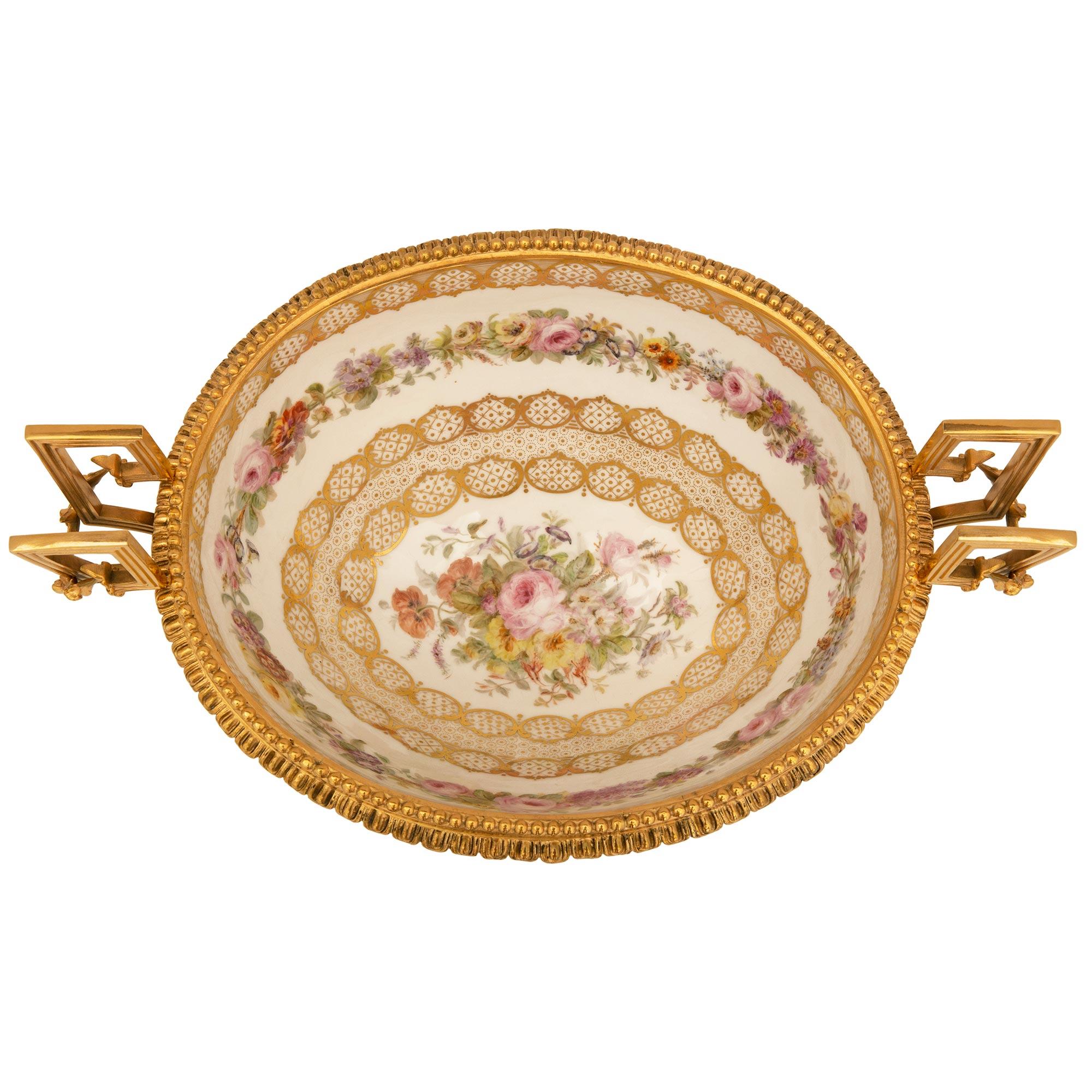 A stunning and very high quality French 19th century Louis XVI St. ormolu and Sevres porcelain centerpiece. The centerpiece is raised by an elegant ormolu base with fine foliate feet, beautiful richly chased frolicking lovebirds and a striking