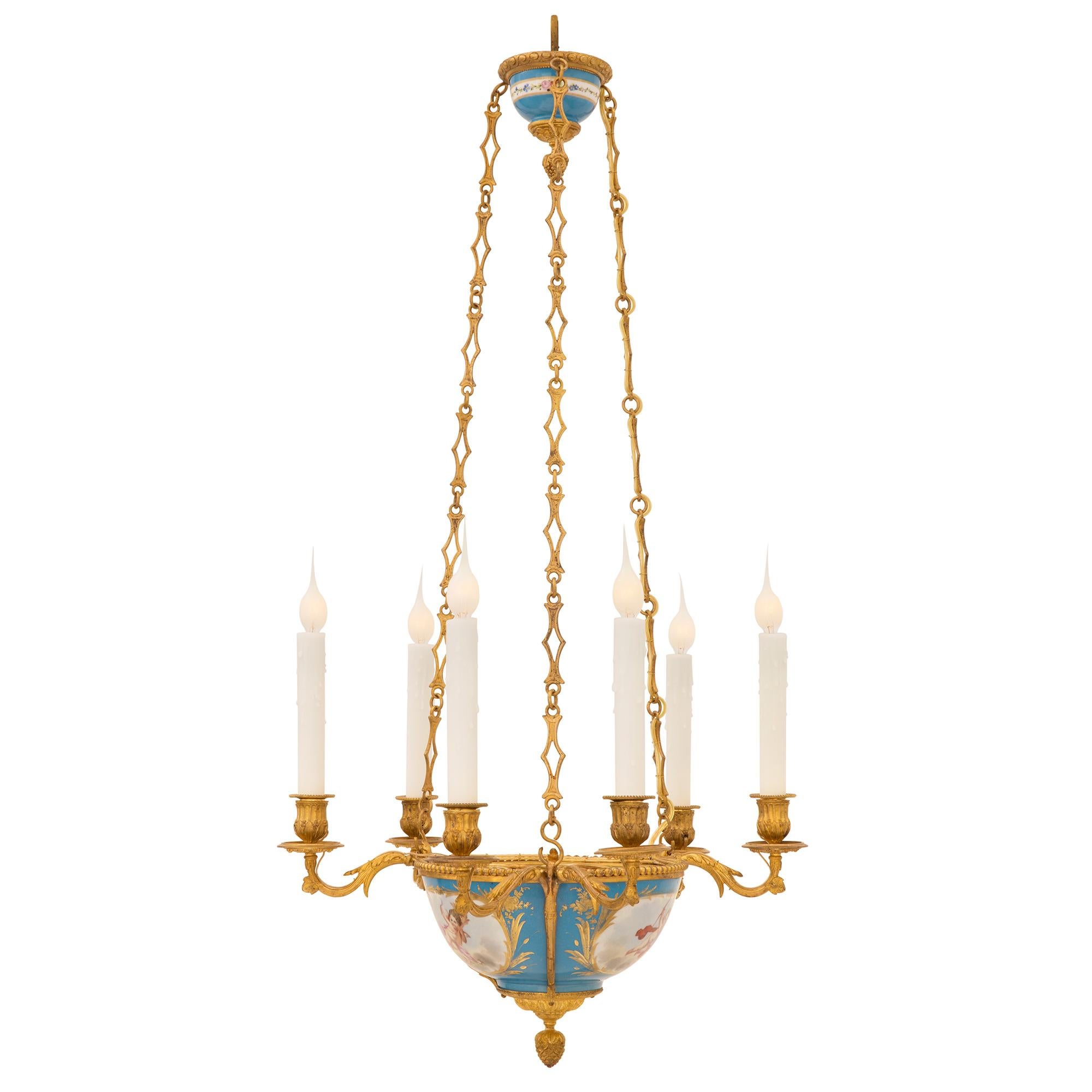 A very elegant and most decorative French 19th century Louis XVI st. ormolu and Sèvres porcelain chandelier. The six light chandelier is centered by a fine bottom acorn finial amidst lovely foliate designs. The beautiful Sévres porcelain body