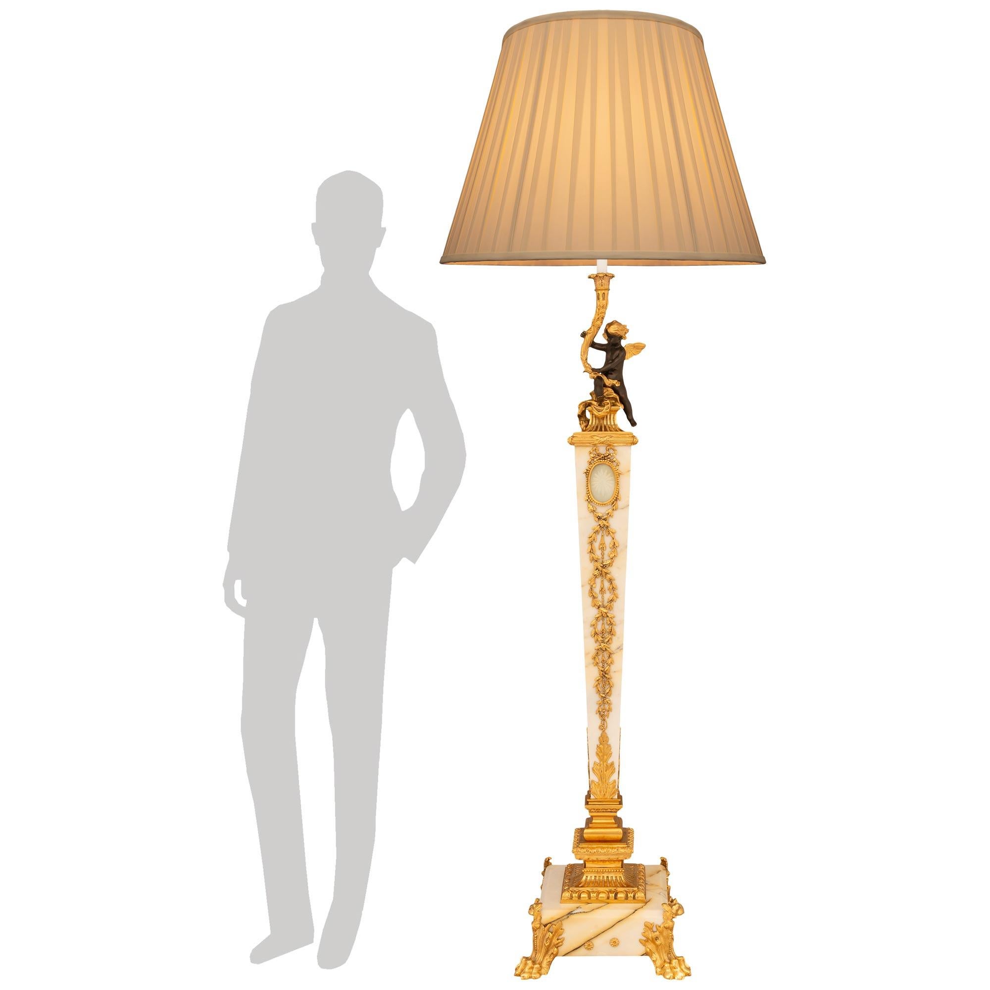 A most elegant and highly detailed French 19th century Louis XVI st. Ormolu, patinated Bronze, etched Crystal and Giallo Antico marble Torchière floor lamp. The floor lamp is raised on a square Giallo Antico marble base with four Ormolu foliate paw