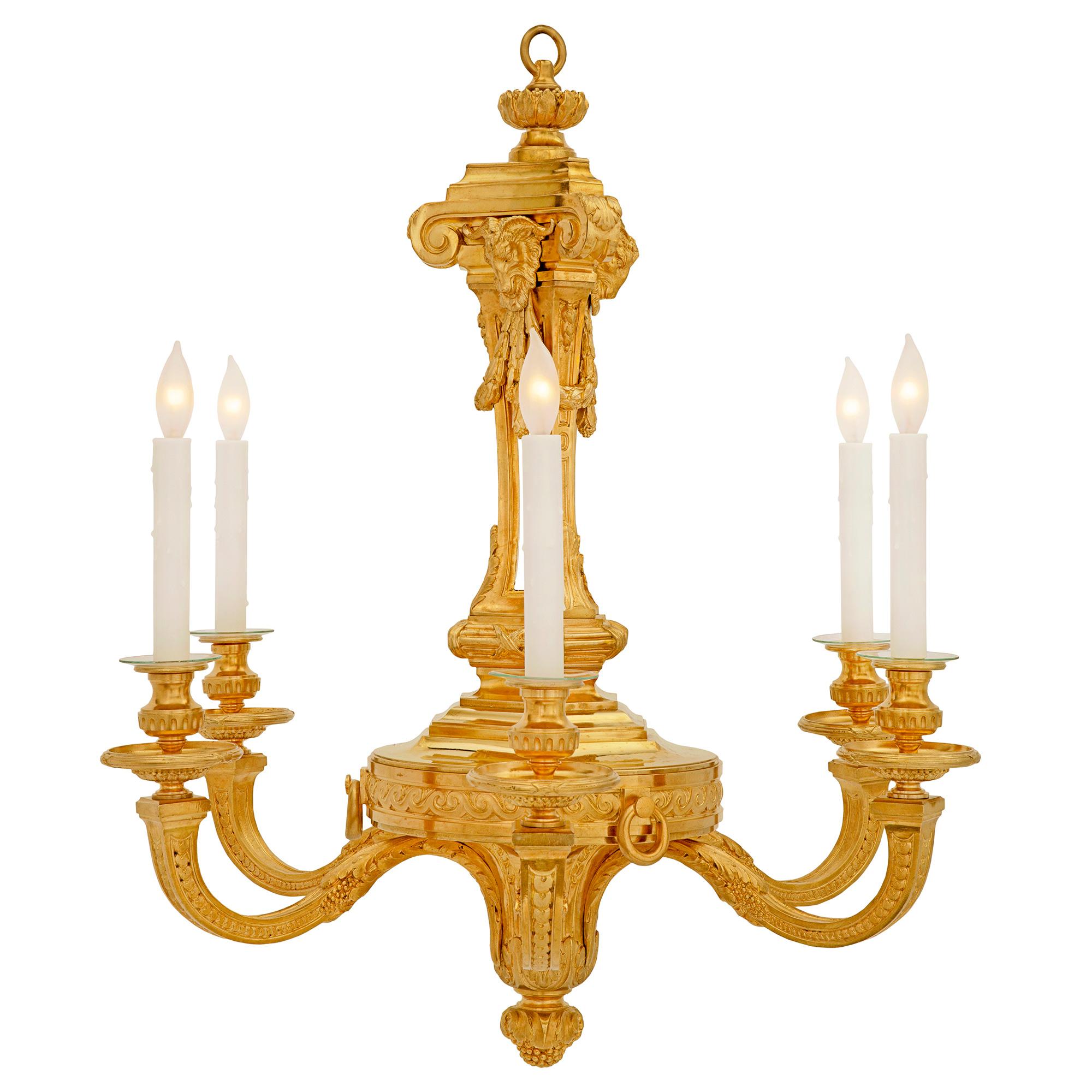 A most handsome French 19th century Louis XVI st. ormolu chandelier. The six arm chandelier is centered by a striking acorn finial with large scrolled acanthus leaves. Each elegant 'S' scrolled arm displays a most decorative overlapping geometric