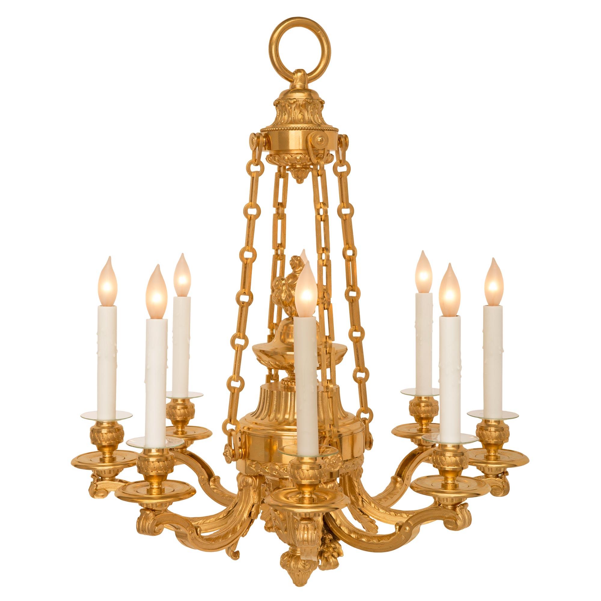 A beautiful and very high quality French 19th century Louis XVI st. ormolu chandelier. The eight arm chandelier is centered by a finely detailed bottom acorn final amidst beautiful acanthus leaf designs. At the center is the elegant lightly curved