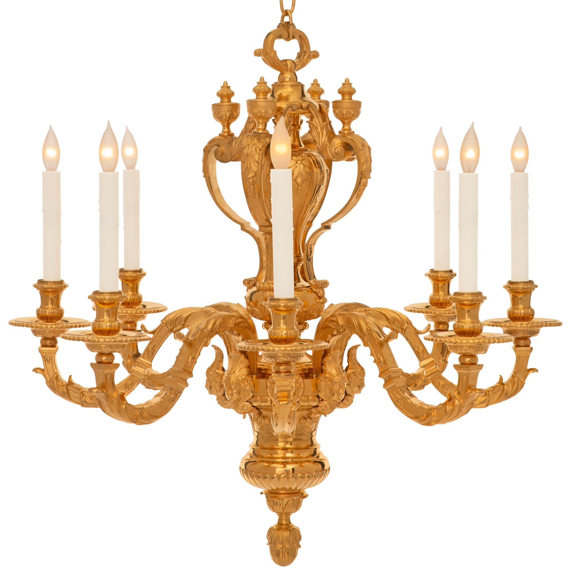 A most impressive French 19th century Louis XVI st. ormolu chandelier. The eight arm chandelier is centered by a striking bottom foliate finial below a reeded design and the elegantly curved body decorated with richly chased reserves of beautiful