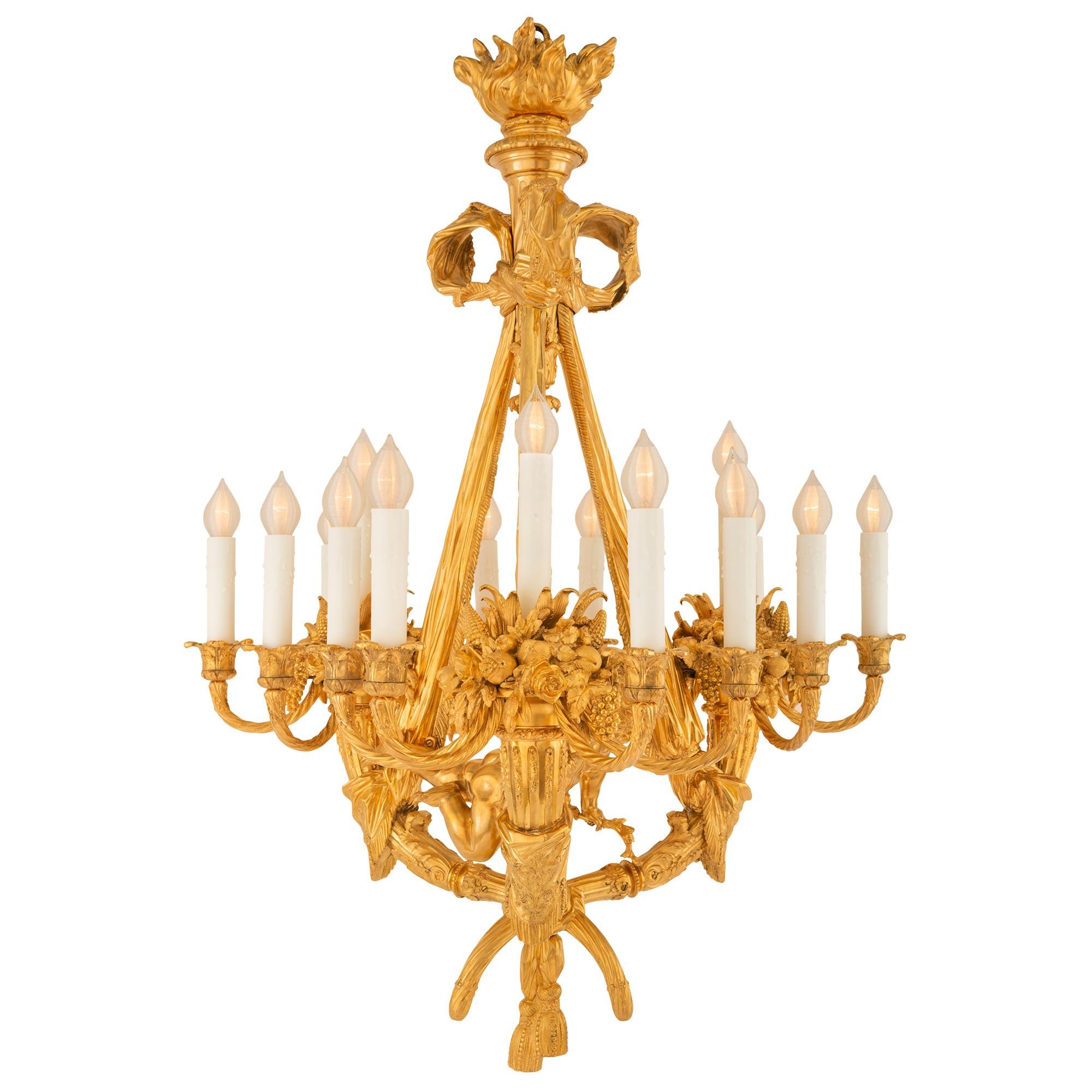 A spectacular and most impressive French 19th century Louis XVI st. ormolu chandelier. This important fifteen light chandelier is centered by striking and wonderfully executed tied garlands with charming finely detailed tassels tied at the center