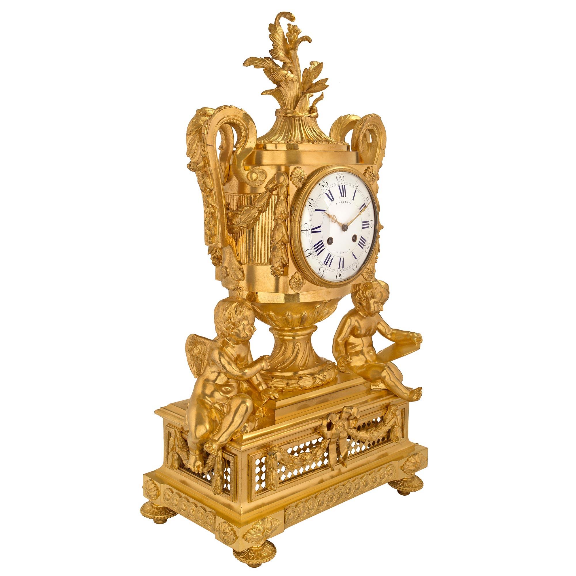 An extremely decorative and large scale French 19th century Louis XVI st. ormolu clock signed Cheuret à Marseilles. The clock is raised on topie feet below a straight frieze with protruding corners decorated by an entrelac pattern with finely chased