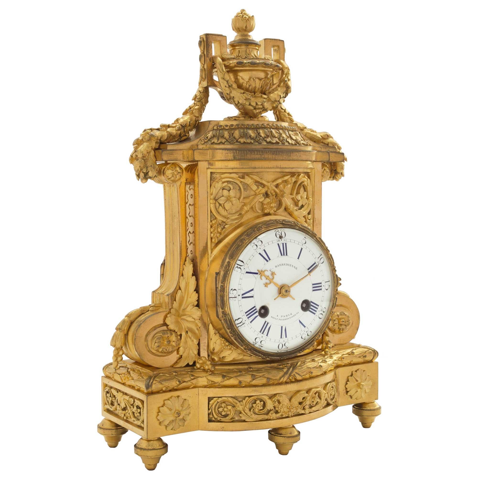 A very elegant and richly chased 19th century French Louis XVI st. ormolu clock signed F. Barbedienne. The clock is raised by five toupee shaped feet. At the frieze are two rosettes encompassing a Rinceau design below the berried laurel band. Above