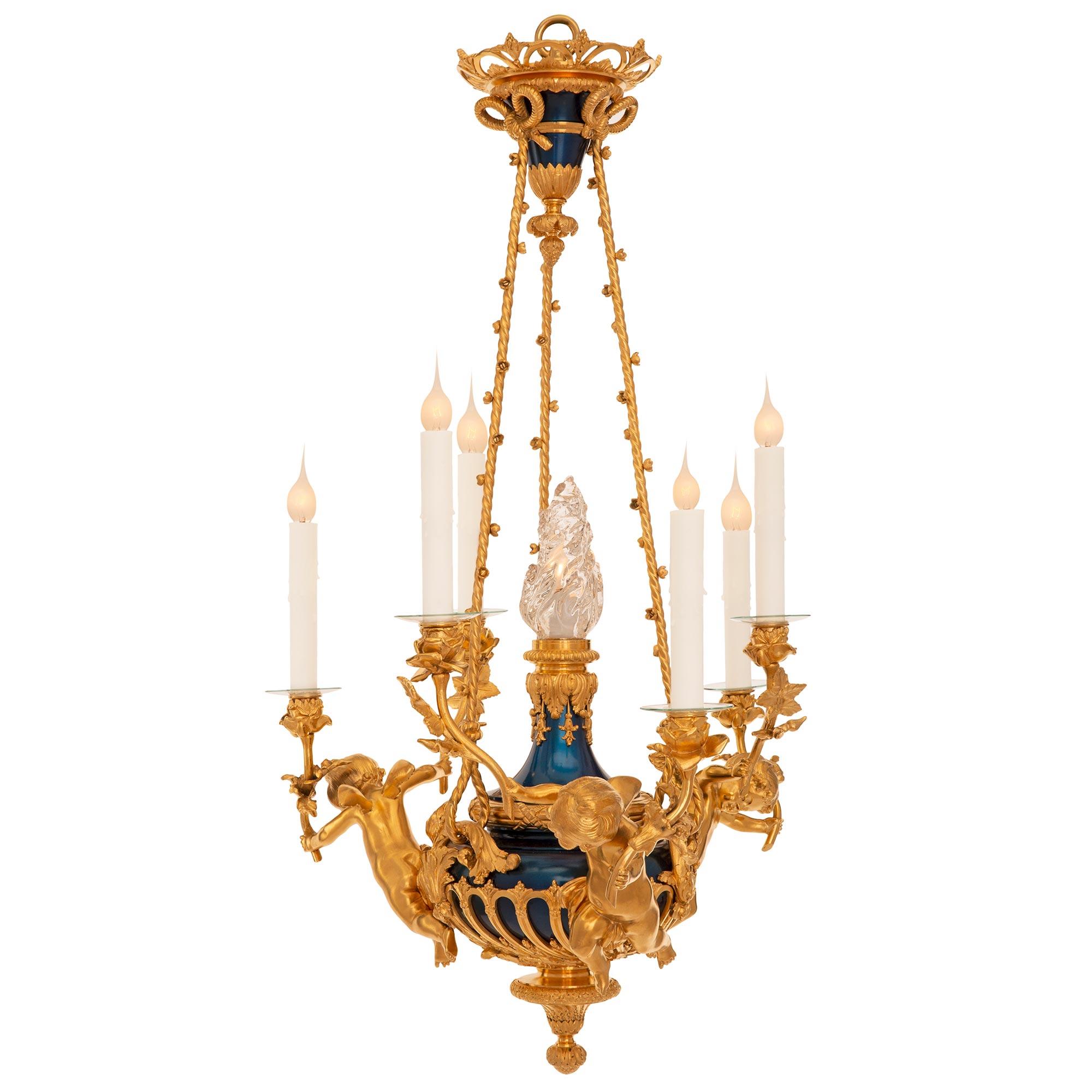 A stunning and extremely decorative French 19th century Louis XVI st. ormolu, enameled bronze and crystal chandelier. The six arm seven light chandelier is centered by an elegant finely detailed bottom mottled foliate finial with a lovely wrap