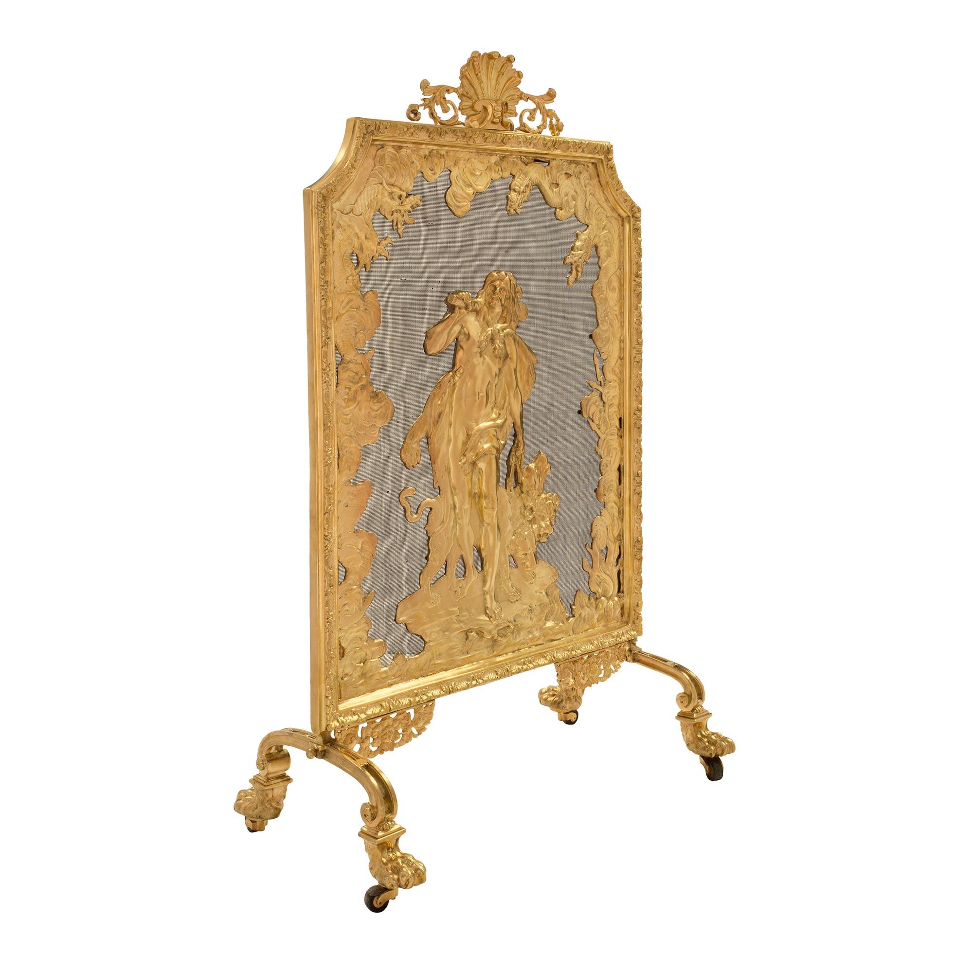 An elegant French 19th century Louis XVI st. ormolu fireguard. The fireguard is raised by its original casters under handsome paw feet and scrolled legs. Above are beautiful pierced foliate scrolled movements centering the impressive and finely