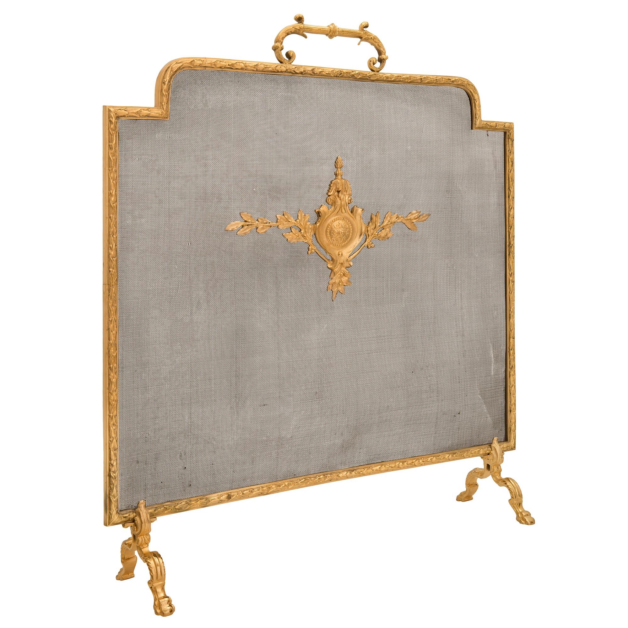 A beautiful and high quality French 19th century Louis XVI st. ormolu fireplace screen. The screen is raised by four elegant scrolled feet with richly chased large acanthus leaves. The original central mesh is centered by a striking and finely
