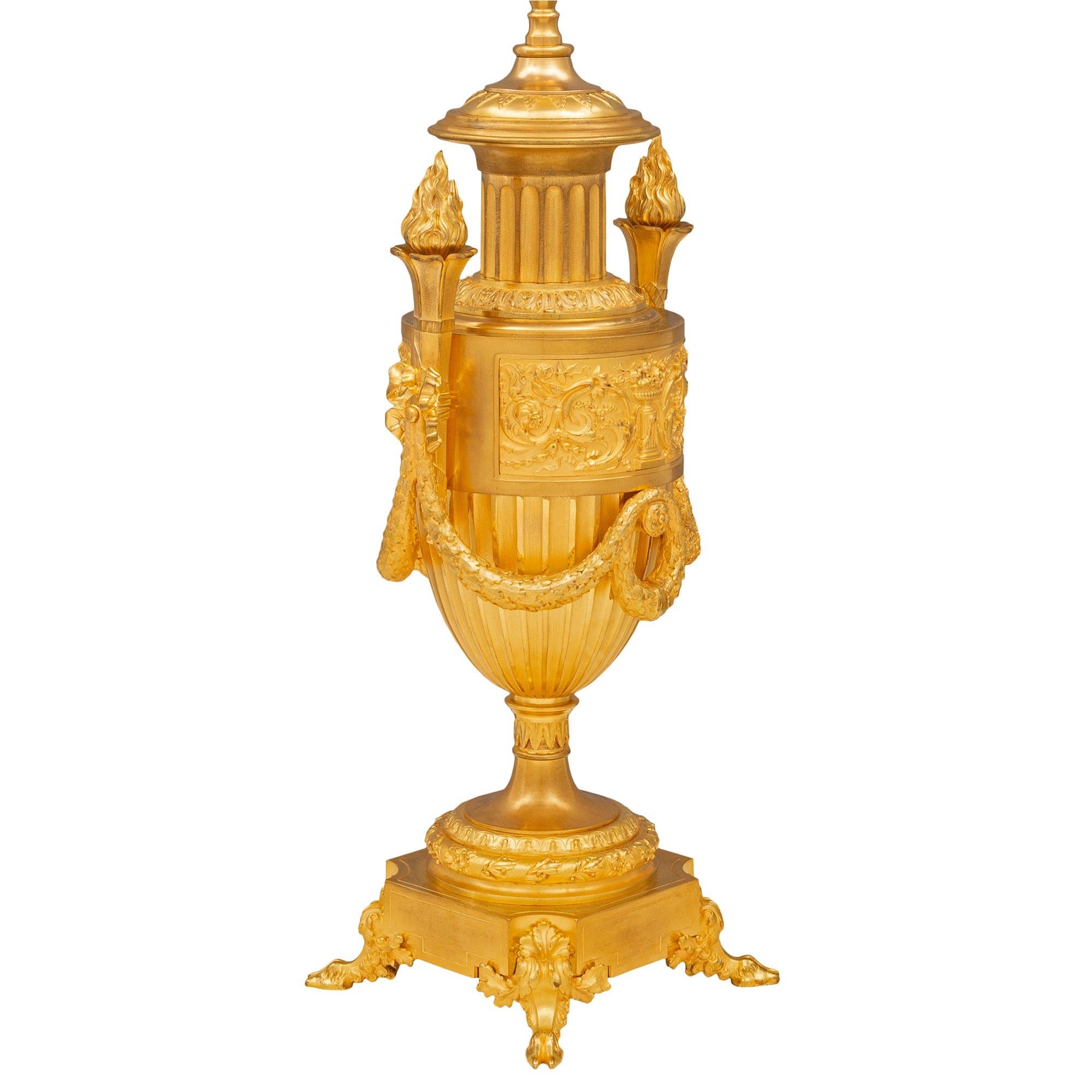 An exceptional French 19th century Louis XVI st. ormolu lamp. The lamp is raised by elegant hoof feet and acanthus leaf supports below the square base with concave corners. The socle shaped pedestal support displays a finely detailed wrap around