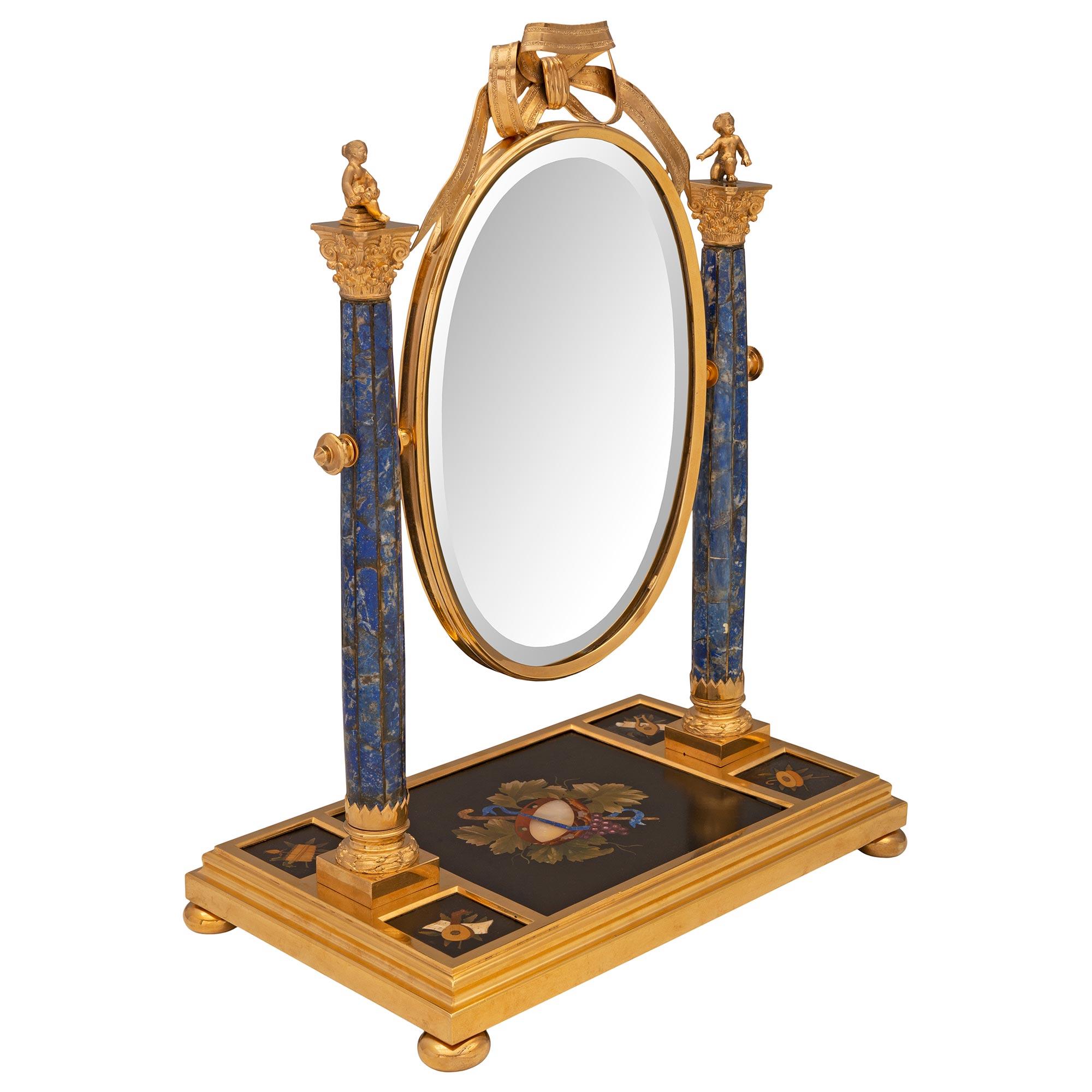 A stunning French mid 19th century Louis XVI st. ormolu, Lapis Lazuli and Pietra Dura vanity mirror. This exceptional and most unique mirror is raised by a rectangular ormolu base with a fine mottled border and lovely ball feet. The base displays