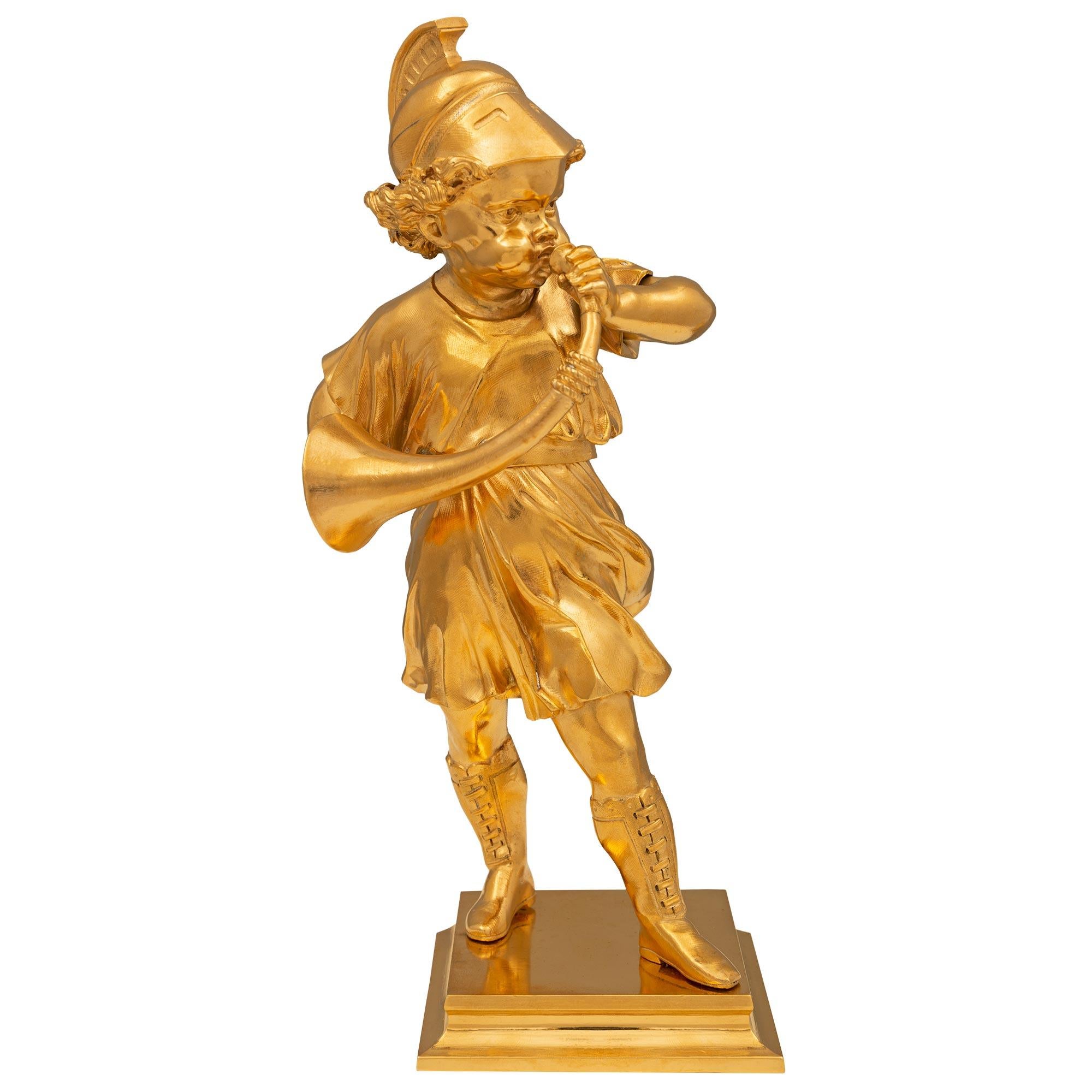 A charming and wonderfully executed French 19th century Louis XVI st. ormolu statue signed Machault. The statue is raised by a square base with an elegant mottled border where the signature is displayed. Above is the young boy wearing boots while