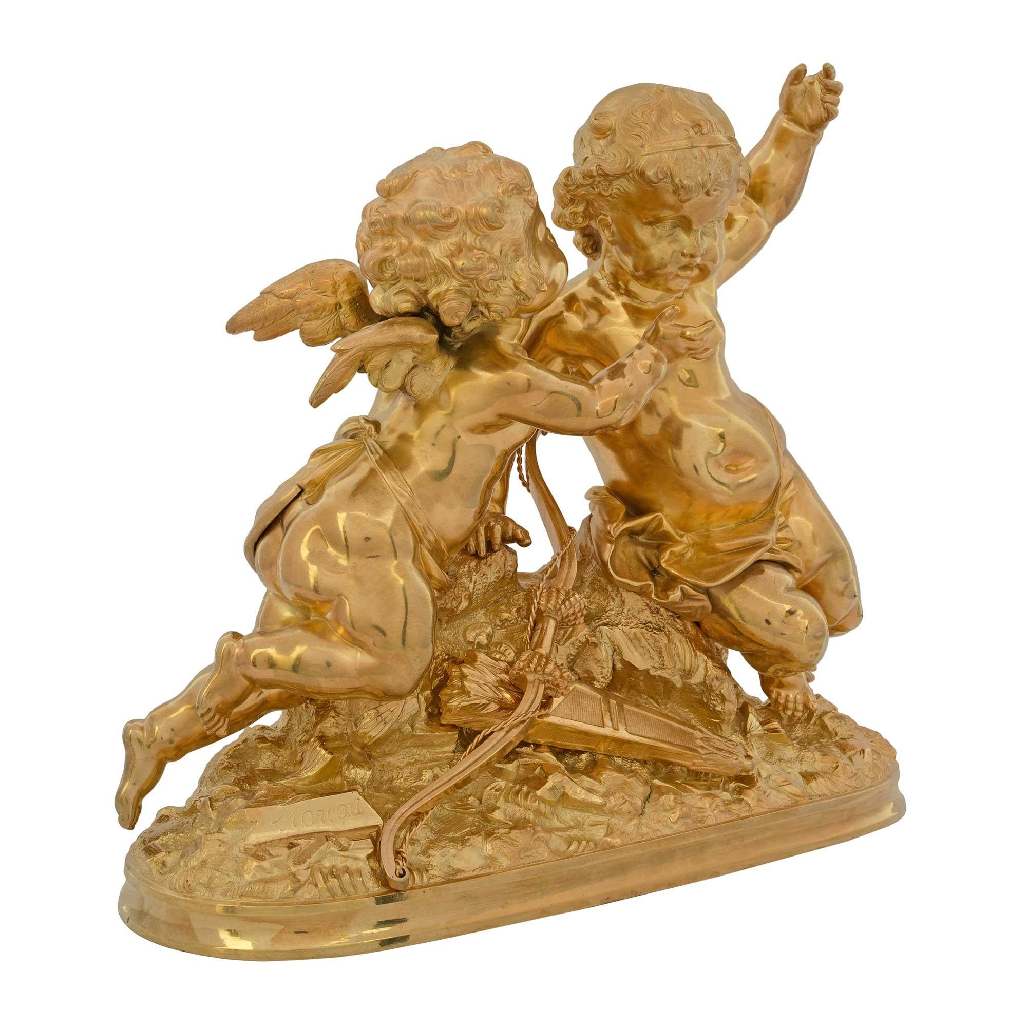 A charming French 19th century Louis XVI st. ormolu statue of two cherubs signed Moreau. The two playful winged cherubs are standing amidst a rocky terrain while one is whispering in the ear of the other. The cherubs are above with their bow and