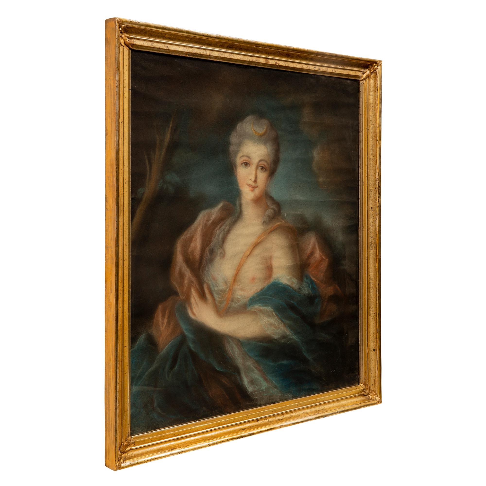 A lovely French 19th century Louis XVI st. pastel of Diana the Huntress. The beautiful pastel is set within its original Mecca frame with glass and a mottled design and elegant foliate carvings at each corner. The wonderfully executed pastel