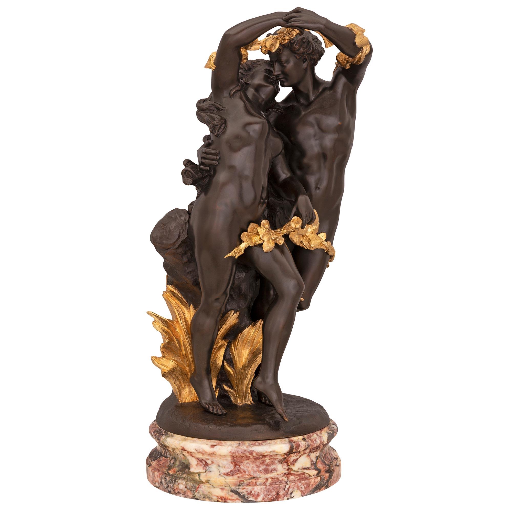 A superb French 19th century Louis XVI st. patinated bronze, ormolu and Serravezza marble statue. The statue is raised by a Fine circular mottled Serravezza marble base where the charming and wonderfully executed naked man and woman are dancing.