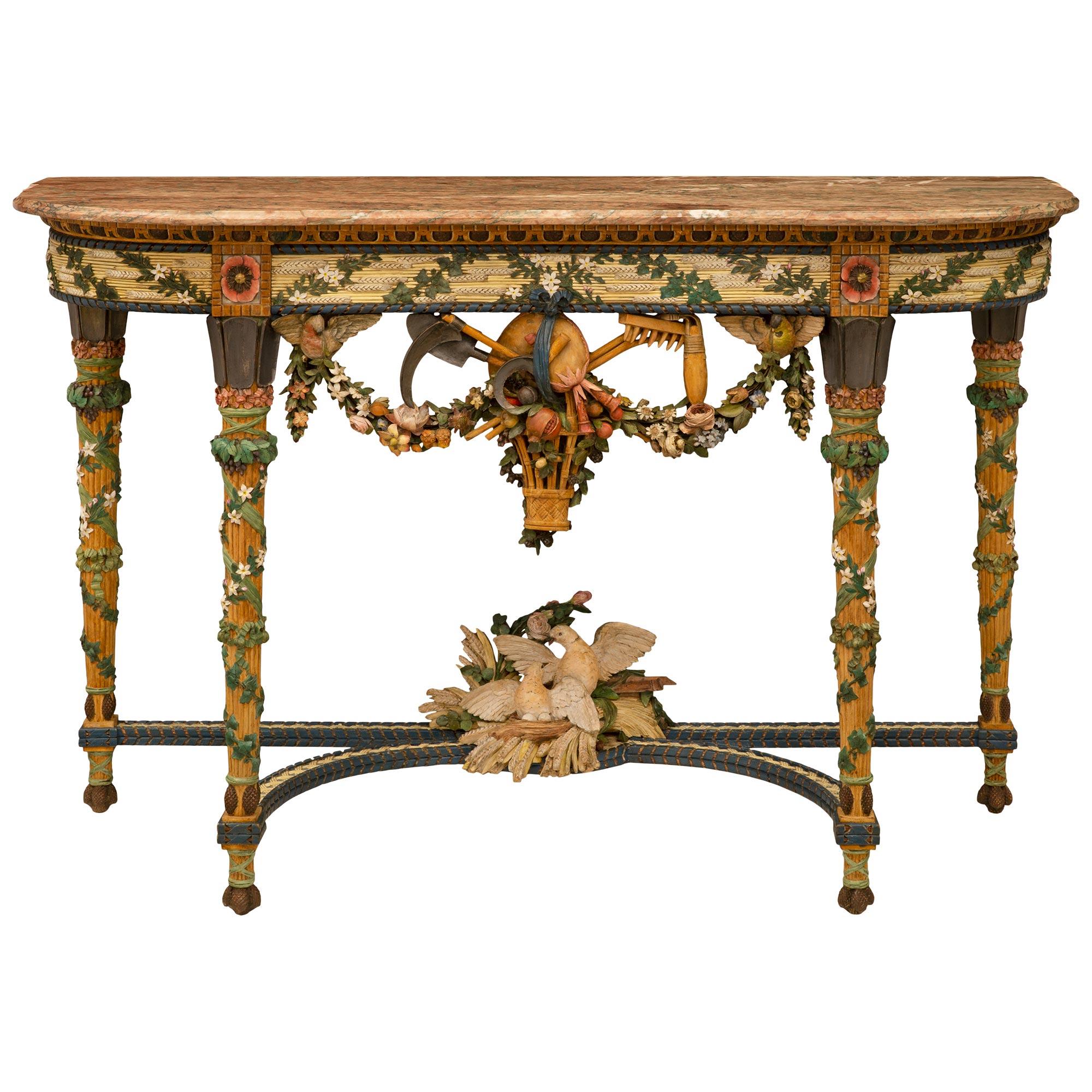 A stunning and extremely decorative French 19th century Louis XVI st. patinated wood and Campan Rubané marble console. The console is raised by elegant circular fluted tapered legs decorated with beautiful tied wrap around garlands and blooming