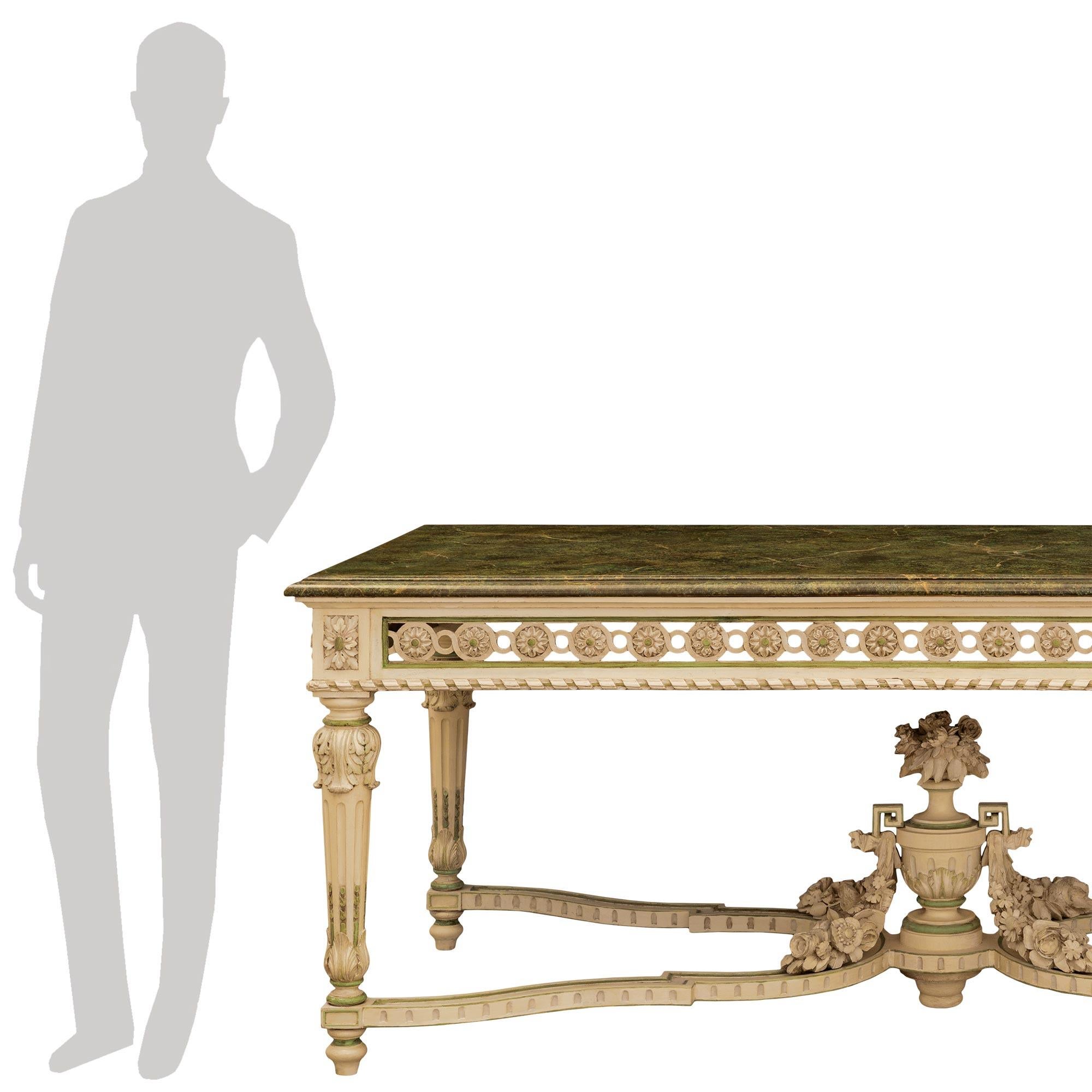 A stunning and extremely decorative French 19th century Louis XVI st. patinated wood and faux painted Vert de Patricia marble center table. The rectangular table is raised by elegant mottled topie shaped feet below impressive tapered fluted baluster